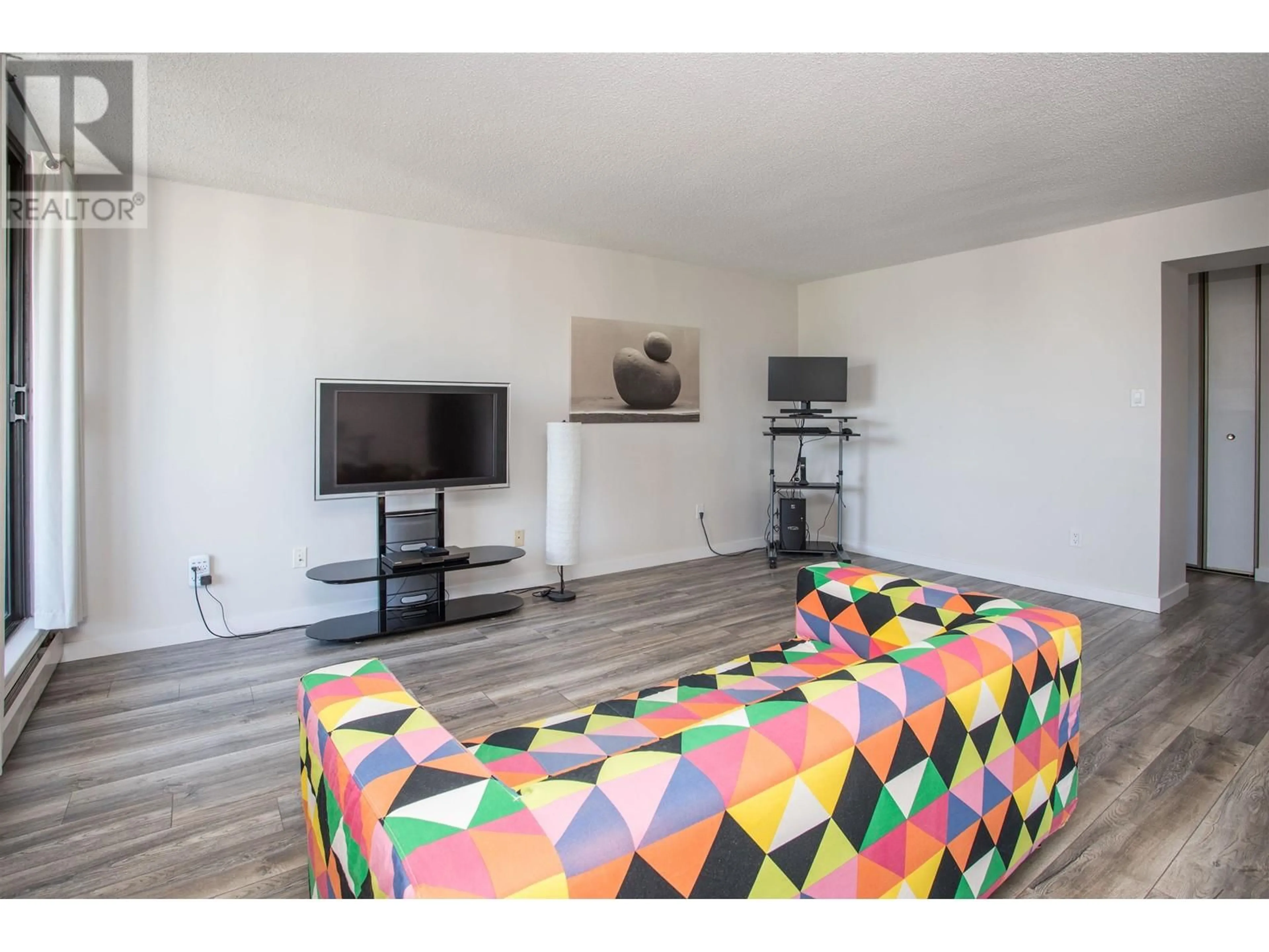 Living room with furniture, wood/laminate floor for 2401 - 3737 BARTLETT COURT, Burnaby British Columbia V3J7E3