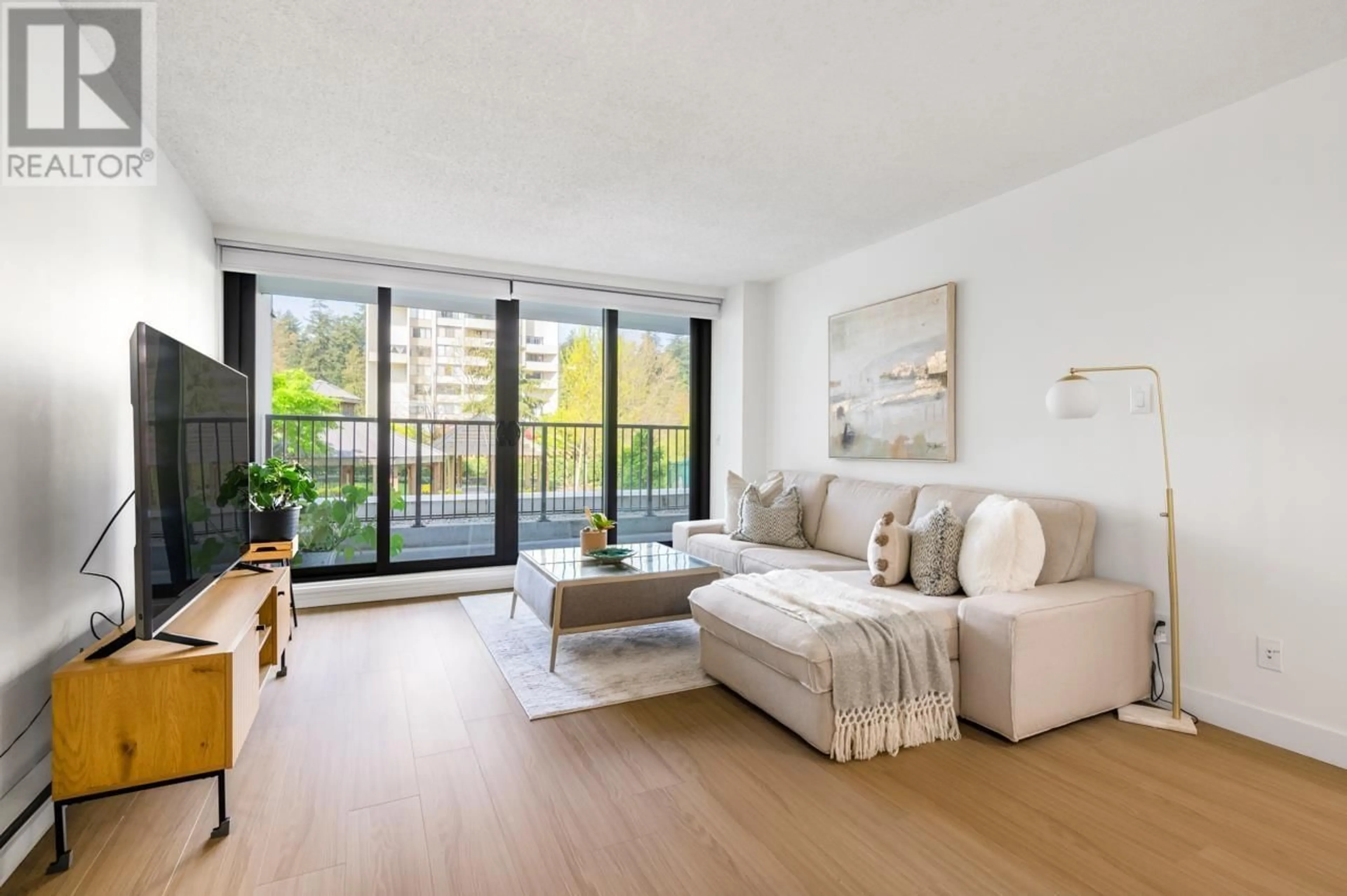 Living room with furniture, wood/laminate floor for 201 - 6455 WILLINGDON AVENUE, Burnaby British Columbia V5H4E4
