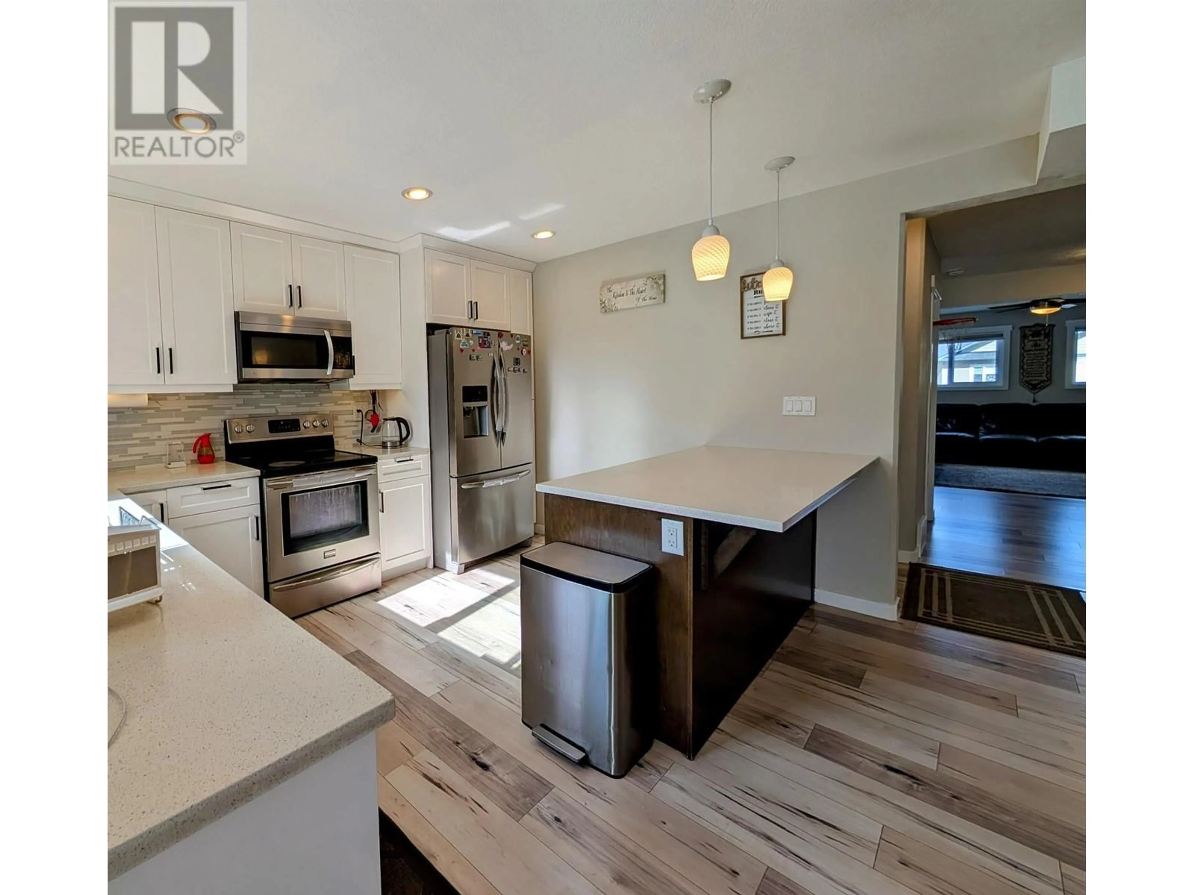 Open concept kitchen, wood/laminate floor for 7669 CREEKSIDE WAY, Prince George British Columbia V2N0C2