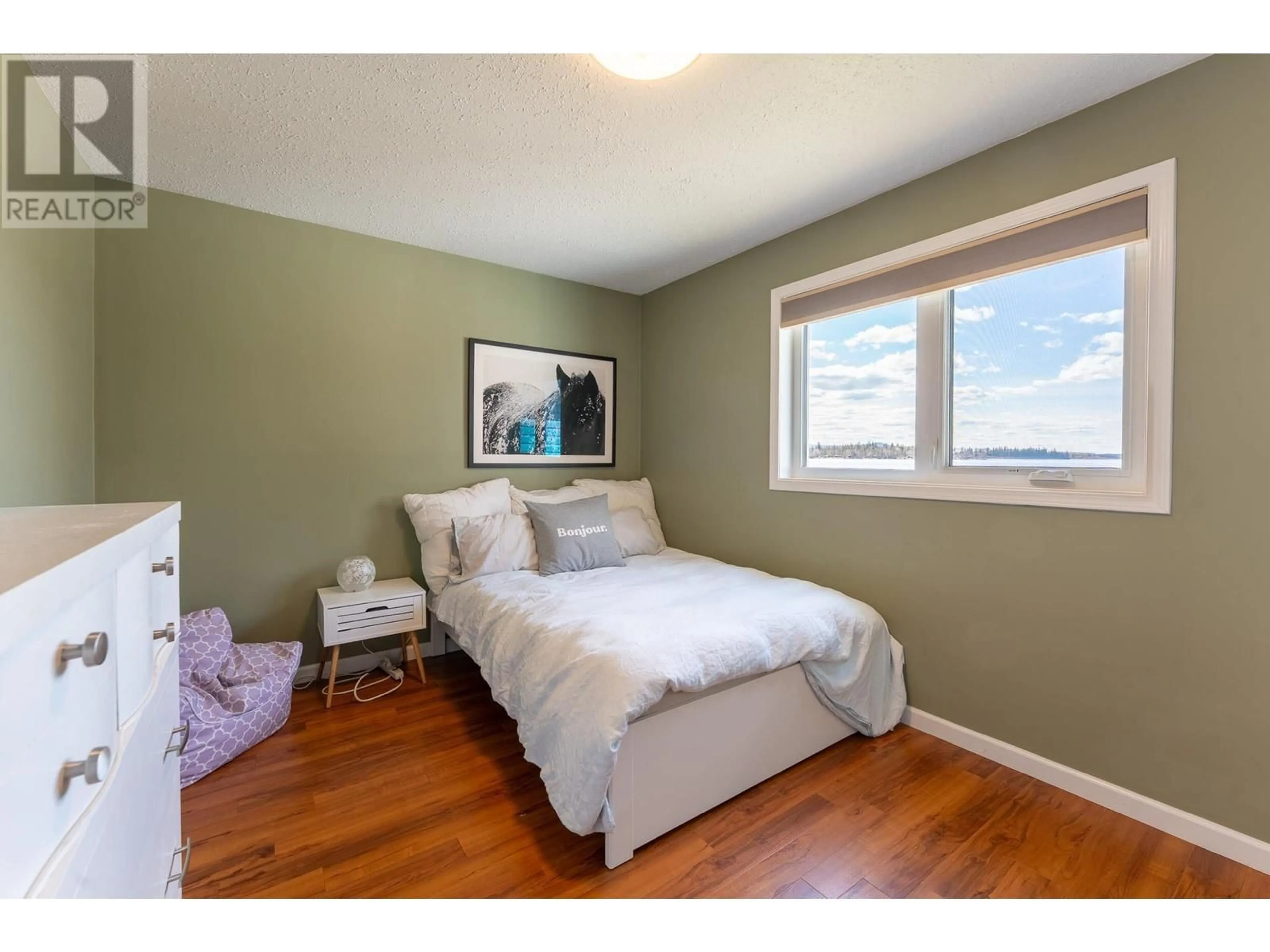 Bedroom with bed, wood/laminate floor for 55680 JARDINE LOOP ROAD, Cluculz Lake British Columbia V0J3A3