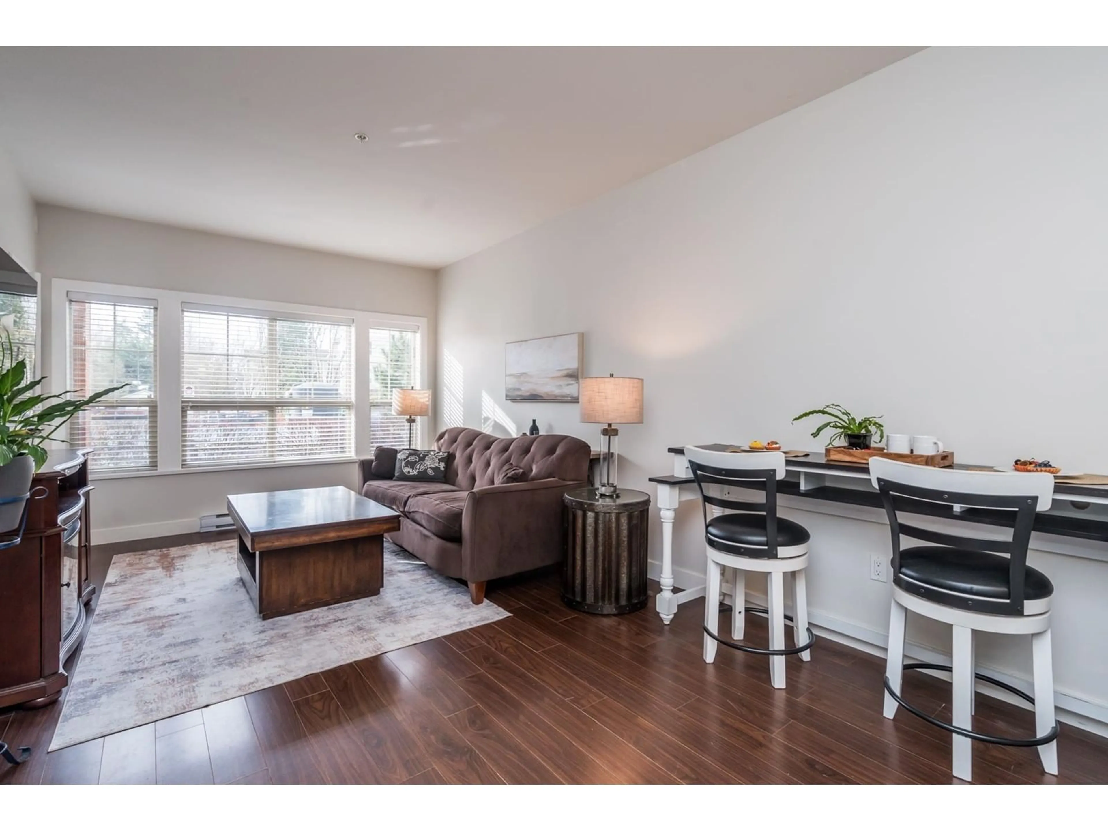 Living room with furniture, wood/laminate floor for 101 - 20219 54A, Langley British Columbia V3A0C7