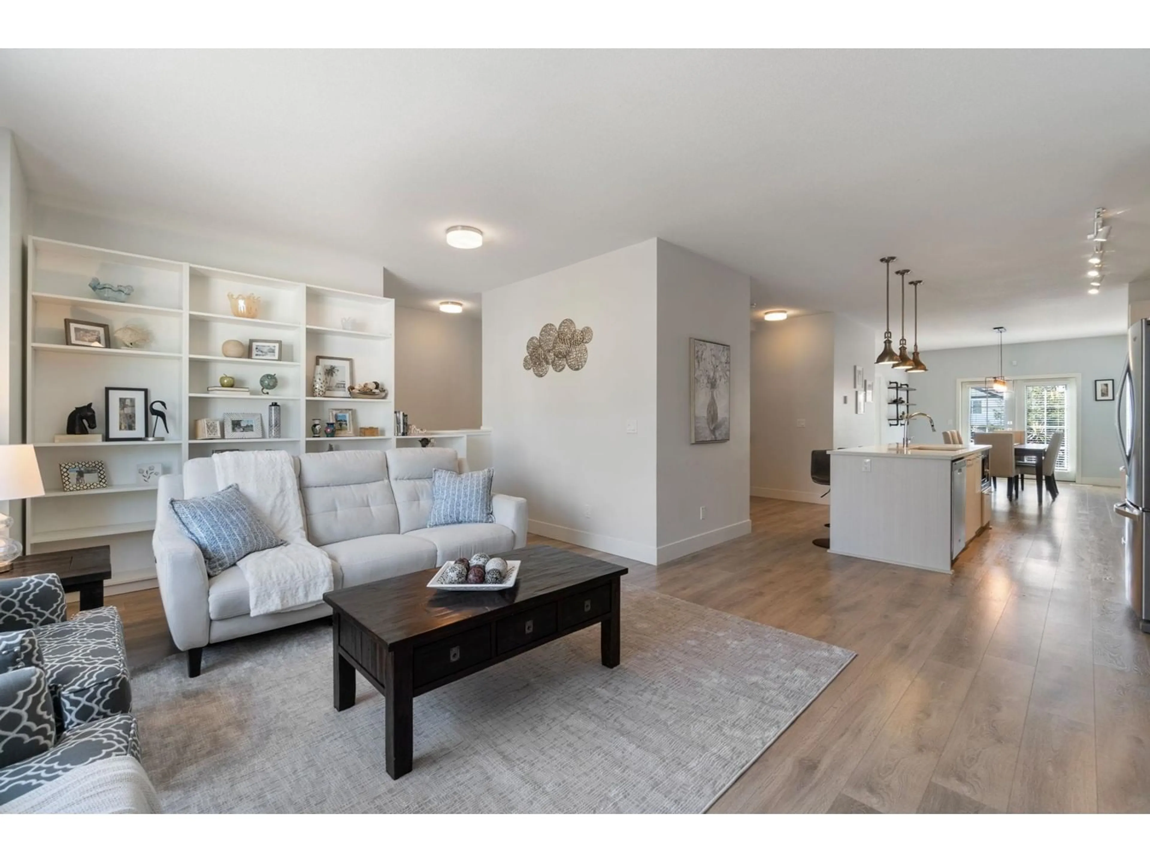 Living room with furniture, wood/laminate floor for 81 - 8217 204B, Langley British Columbia V2Y0V6
