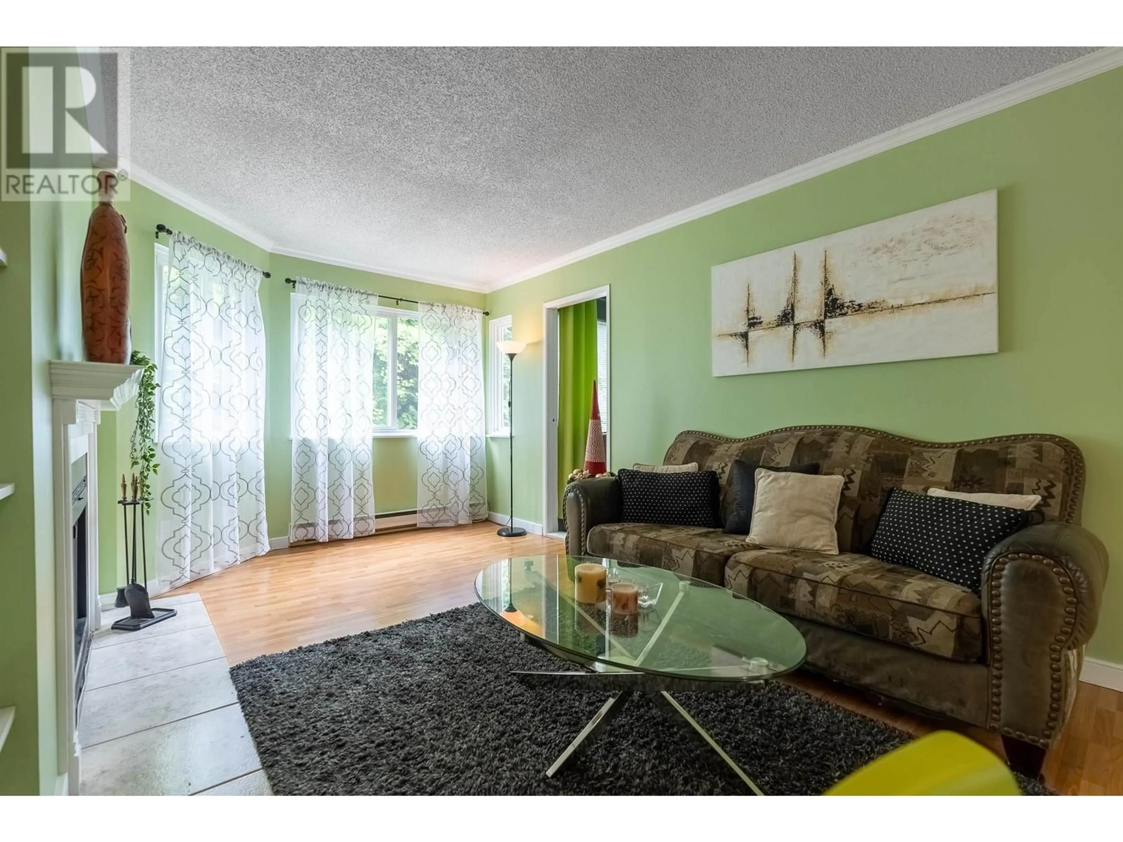 Living room with furniture, wood/laminate floor for 402 - 9880 MANCHESTER DRIVE, Burnaby British Columbia V3N4R3
