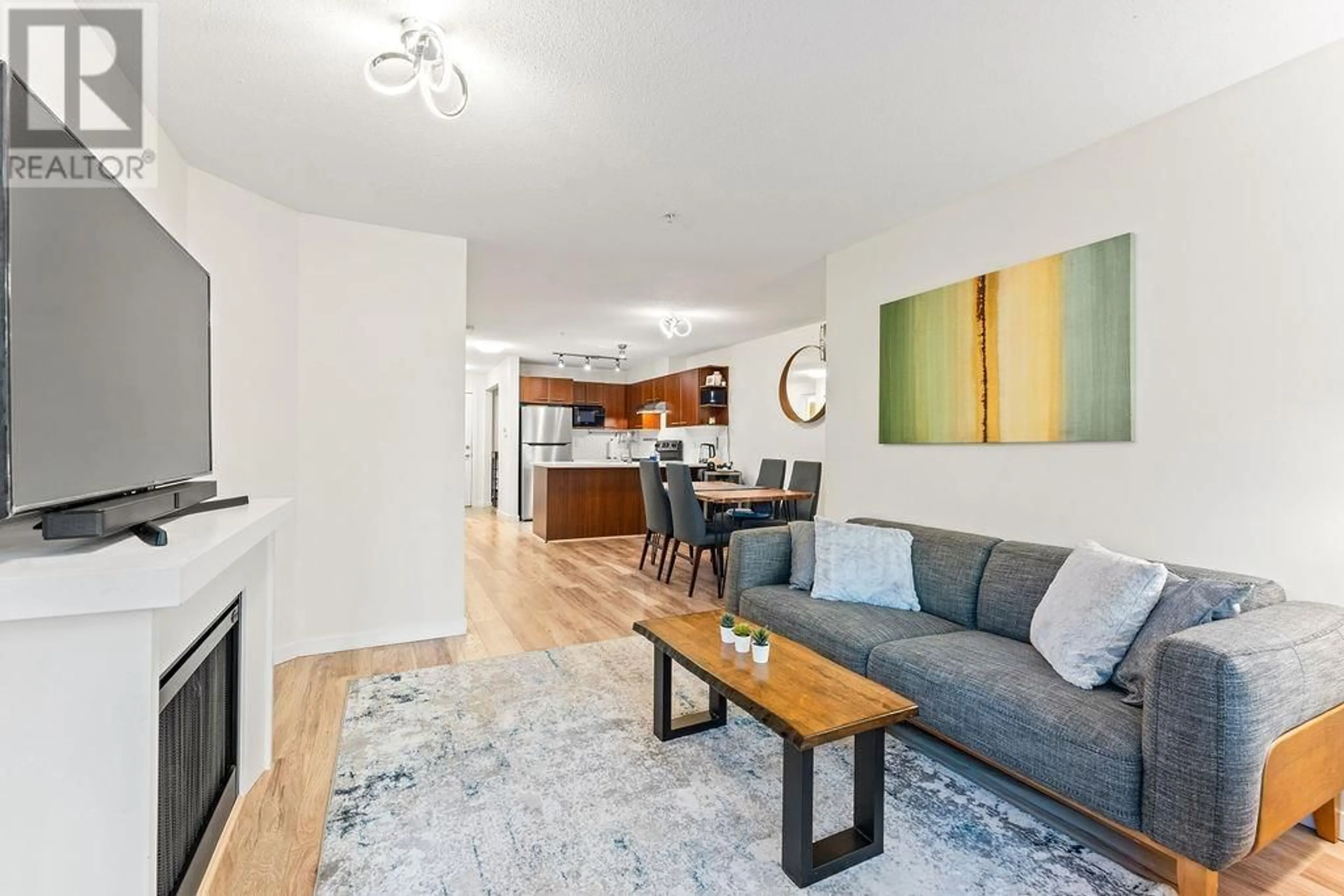 Living room with furniture, wood/laminate floor for 109 - 4868 BRENTWOOD DRIVE, Burnaby British Columbia V5C0C2