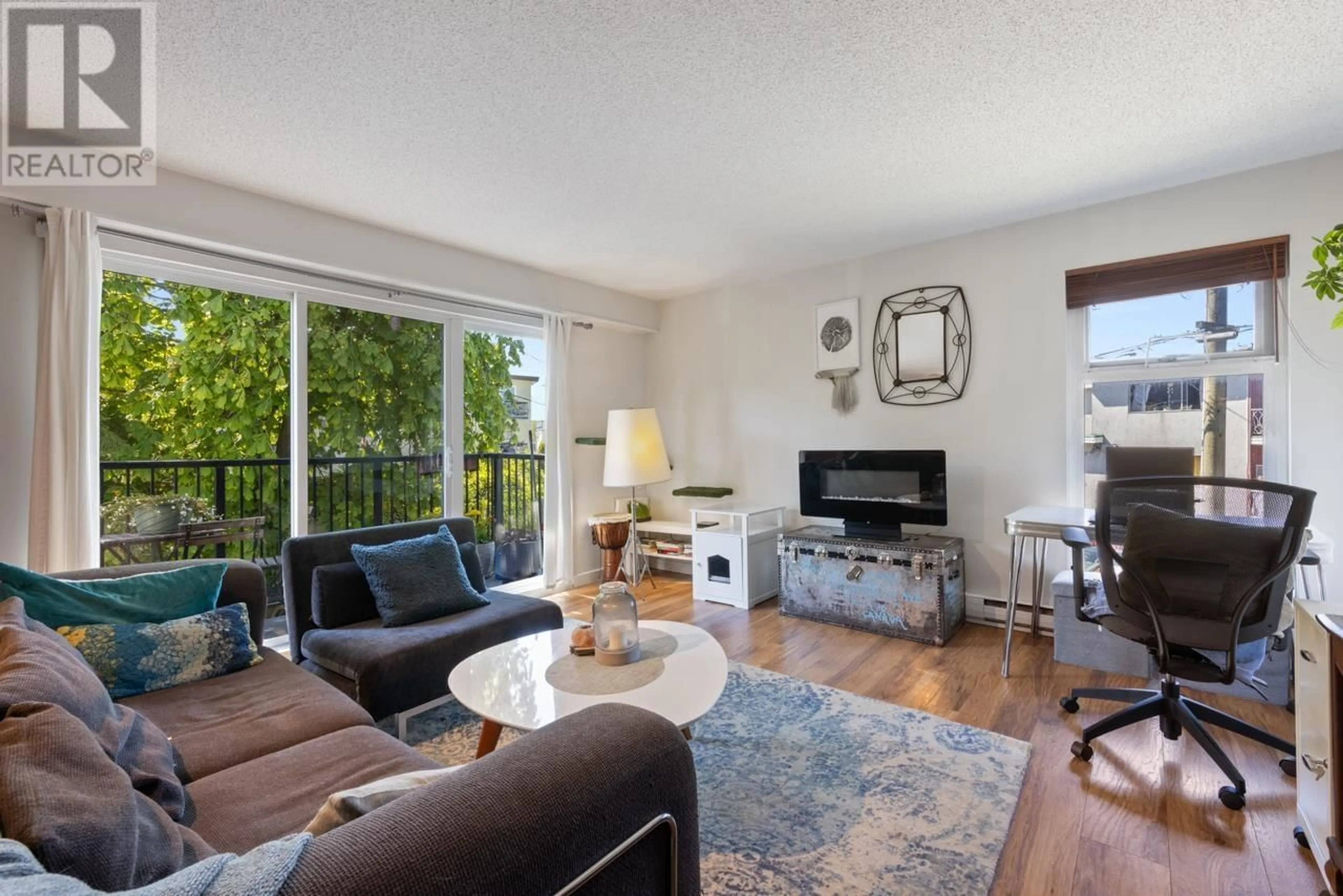 Living room with furniture, wood/laminate floor for 204 - 2244 MCGILL STREET, Vancouver British Columbia V5L1C4