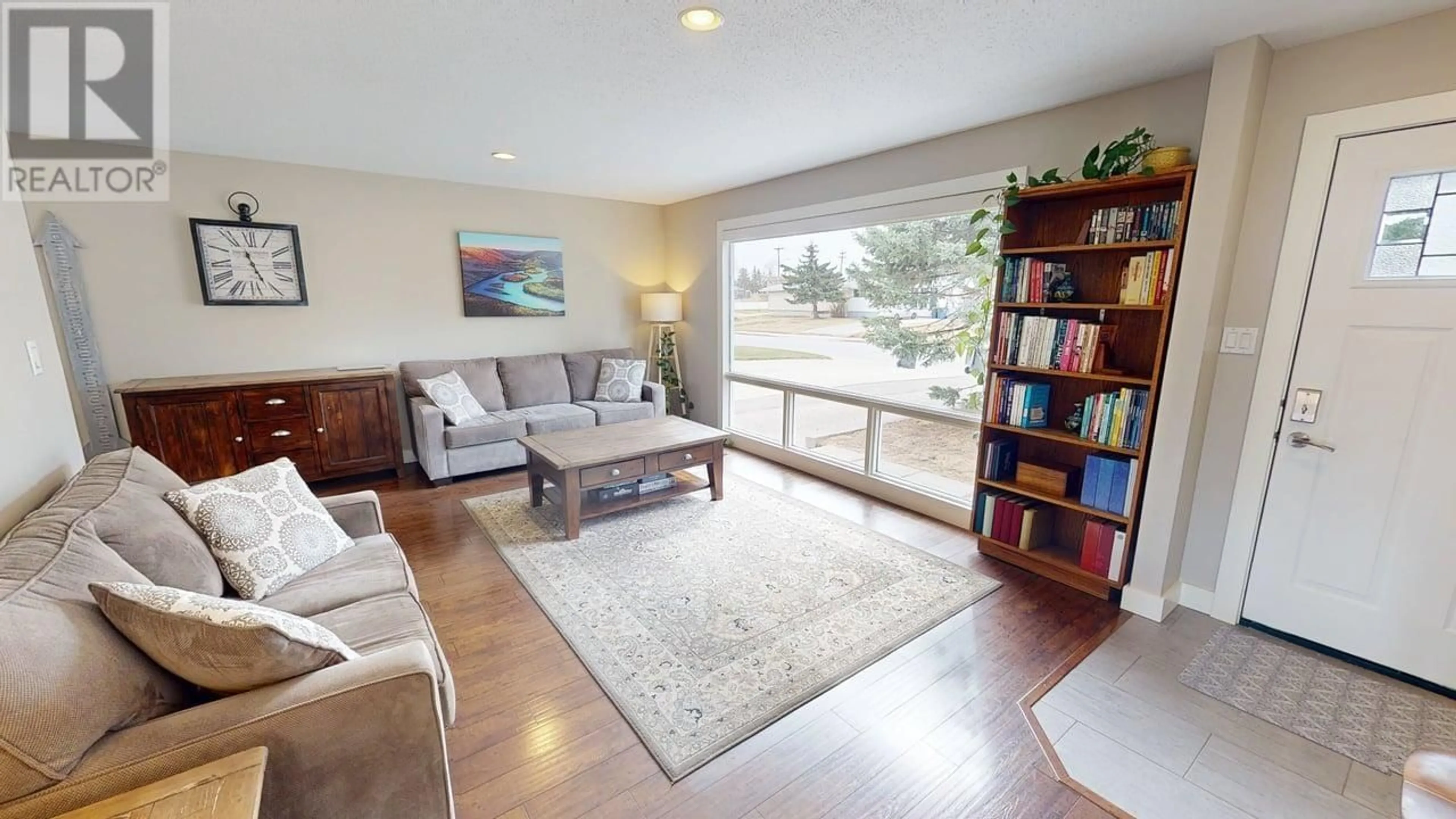 Living room with furniture, wood/laminate floor for 9816 112 AVENUE, Fort St. John British Columbia V1J2W5