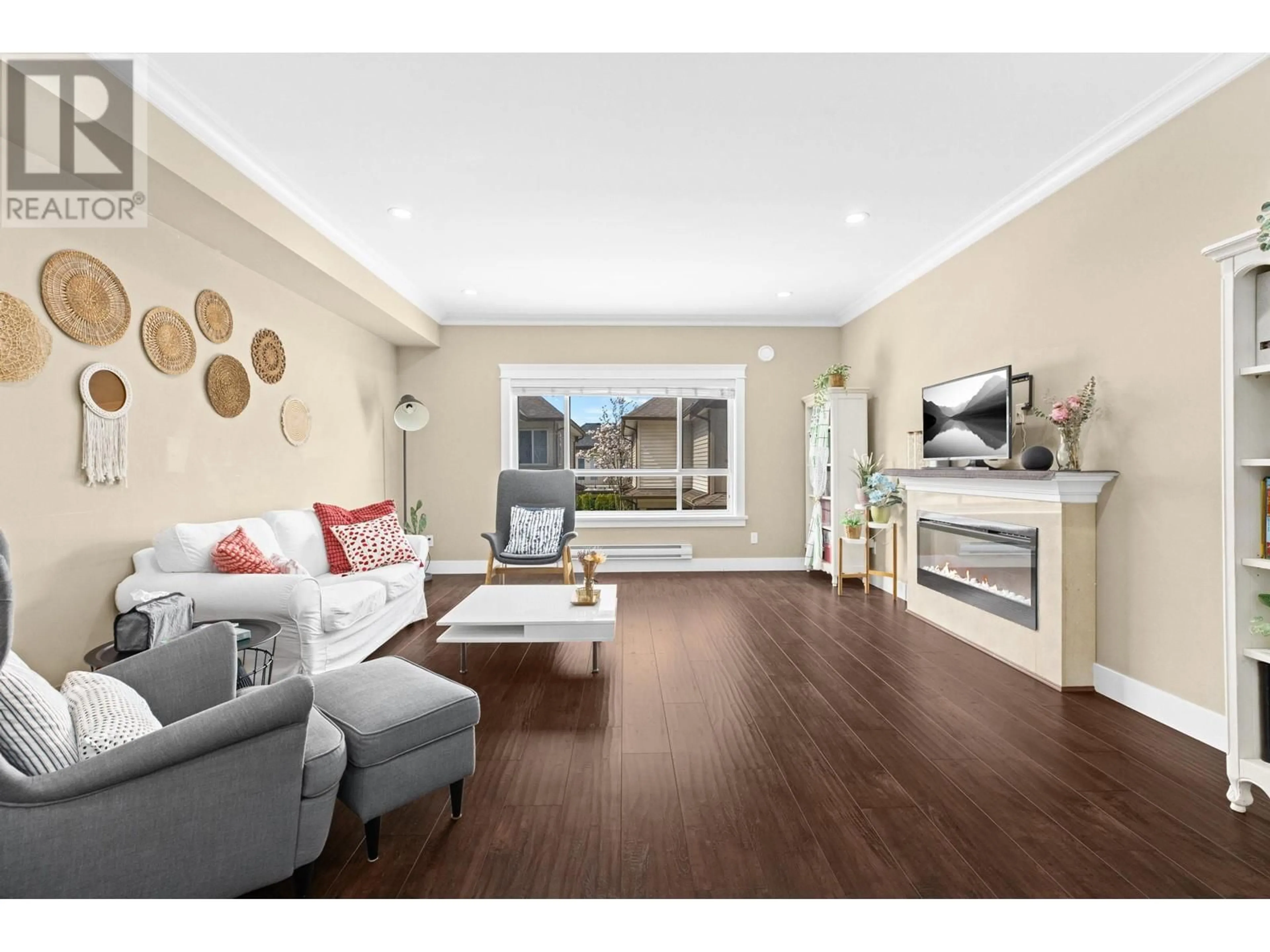 Living room with furniture, wood/laminate floor for 13 - 7551 NO. 2 ROAD, Richmond British Columbia V7C3L7