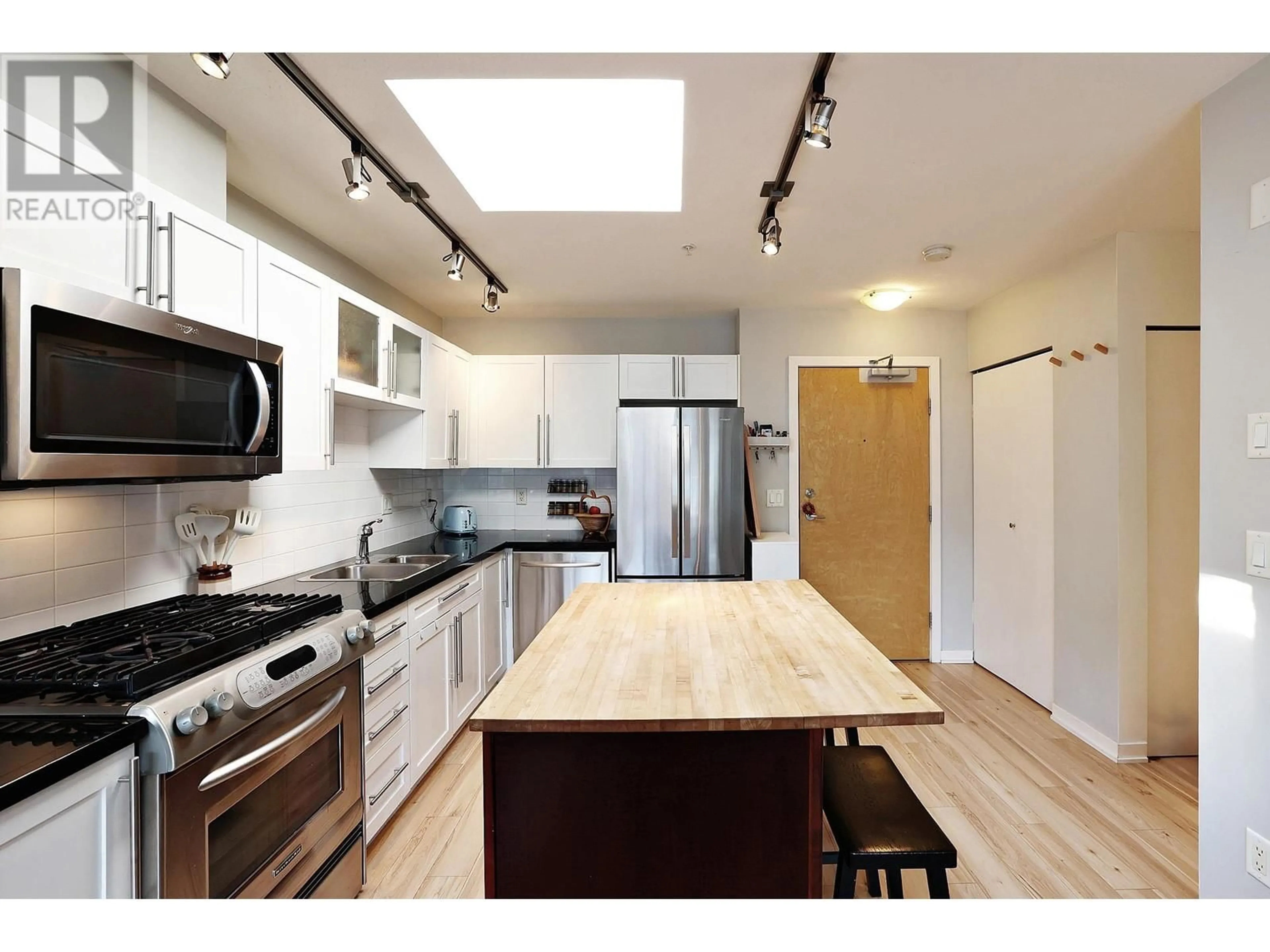 Open concept kitchen, wood/laminate floor for 504 - 122 3RD STREET, North Vancouver British Columbia V7L1E6