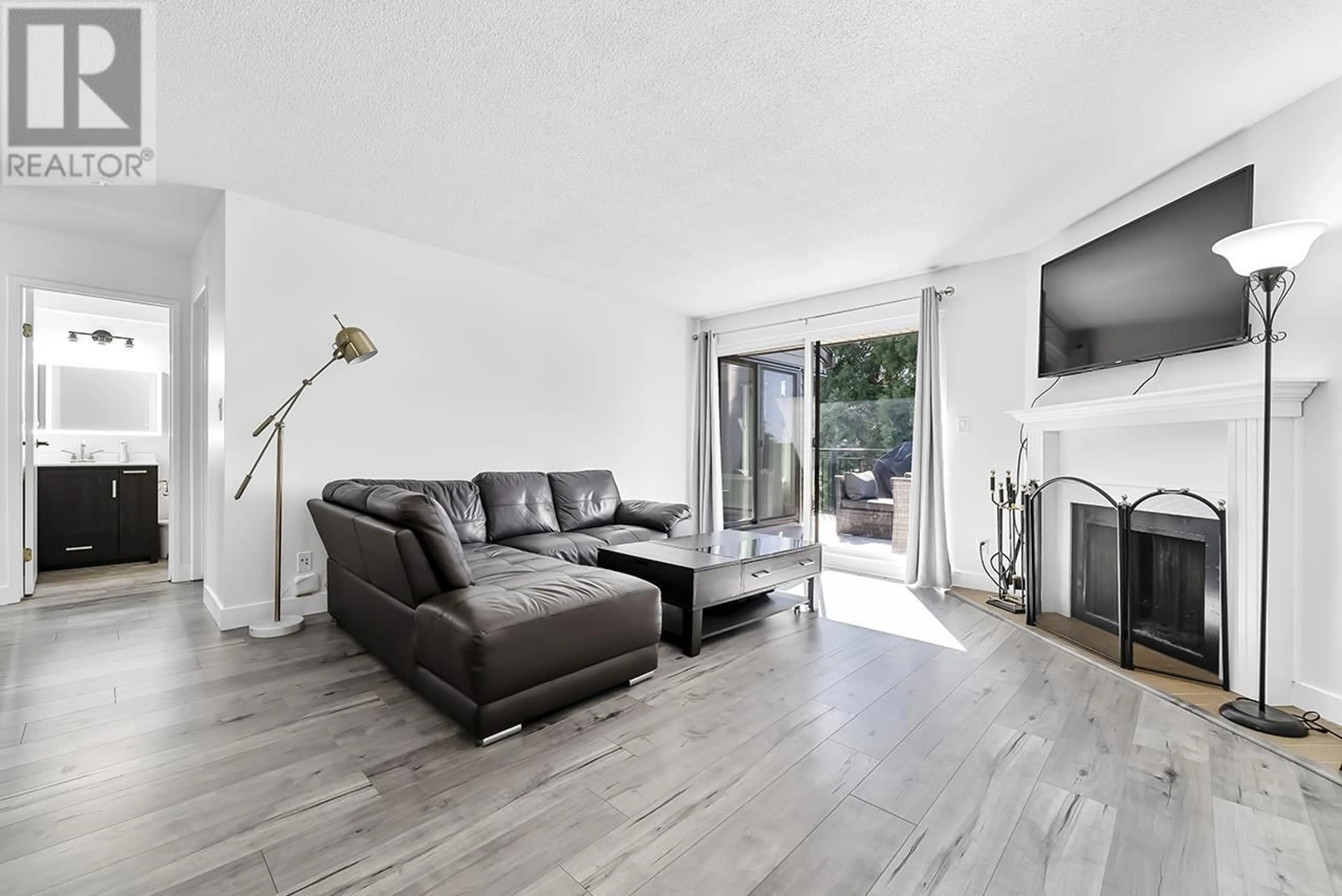 Living room with furniture, wood/laminate floor for 301 - 7871 NO. 1 ROAD, Richmond British Columbia V7C1T7