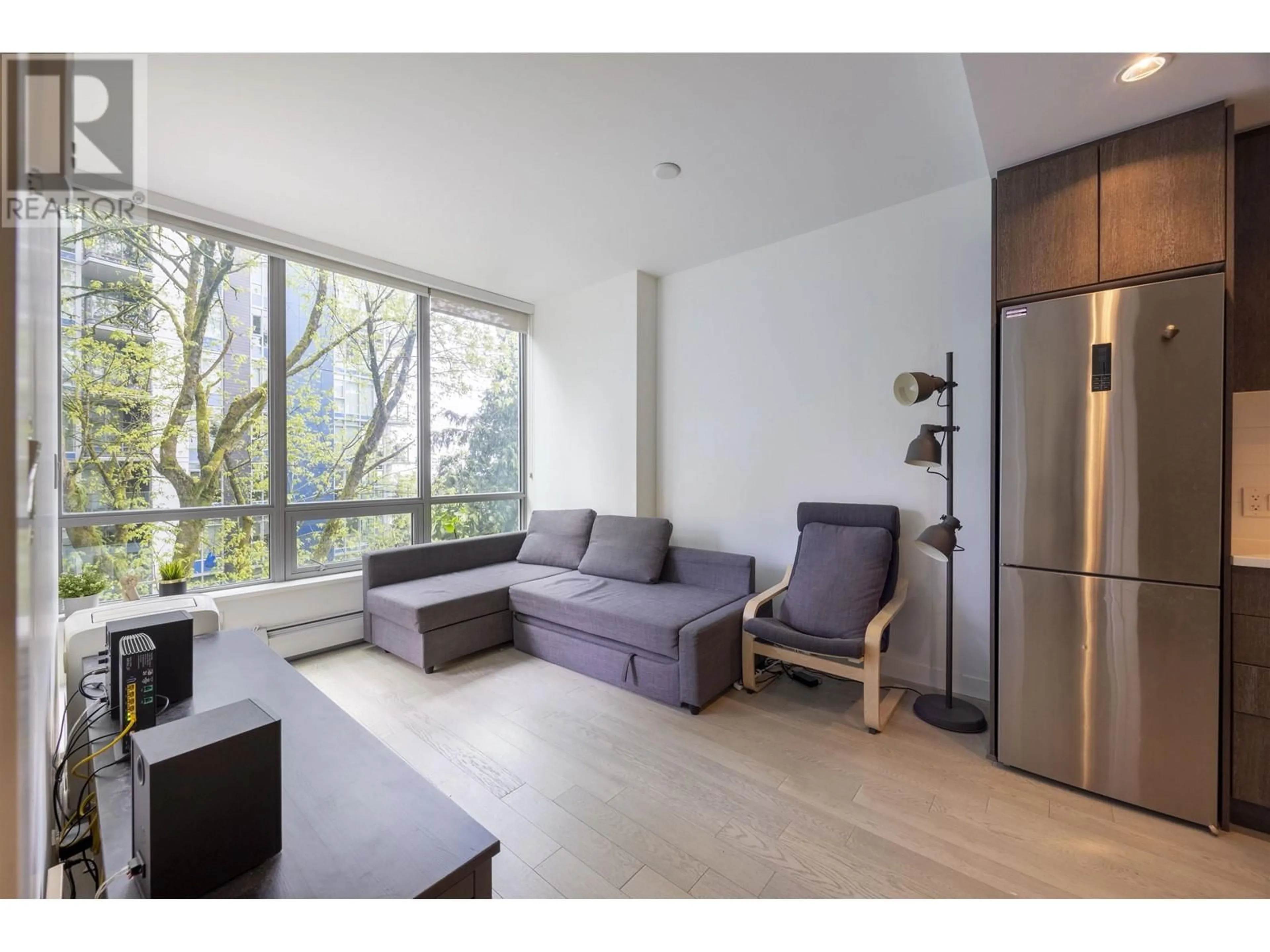 Living room with furniture, wood/laminate floor for 305 - 9060 UNIVERSITY CRESCENT, Burnaby British Columbia V5A0E1
