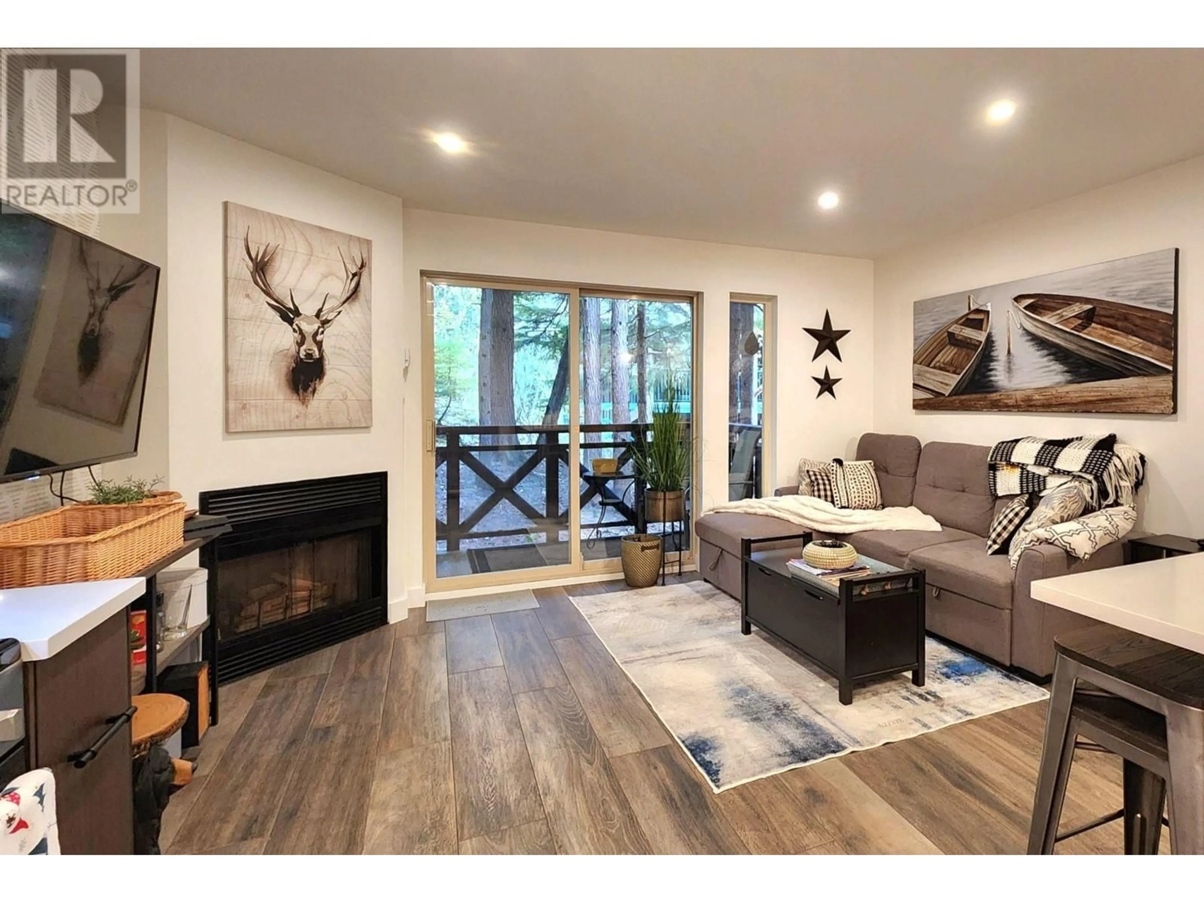 Living room with furniture, wood/laminate floor for 124 - 3070 HILLCREST DRIVE, Whistler British Columbia V8E0V1