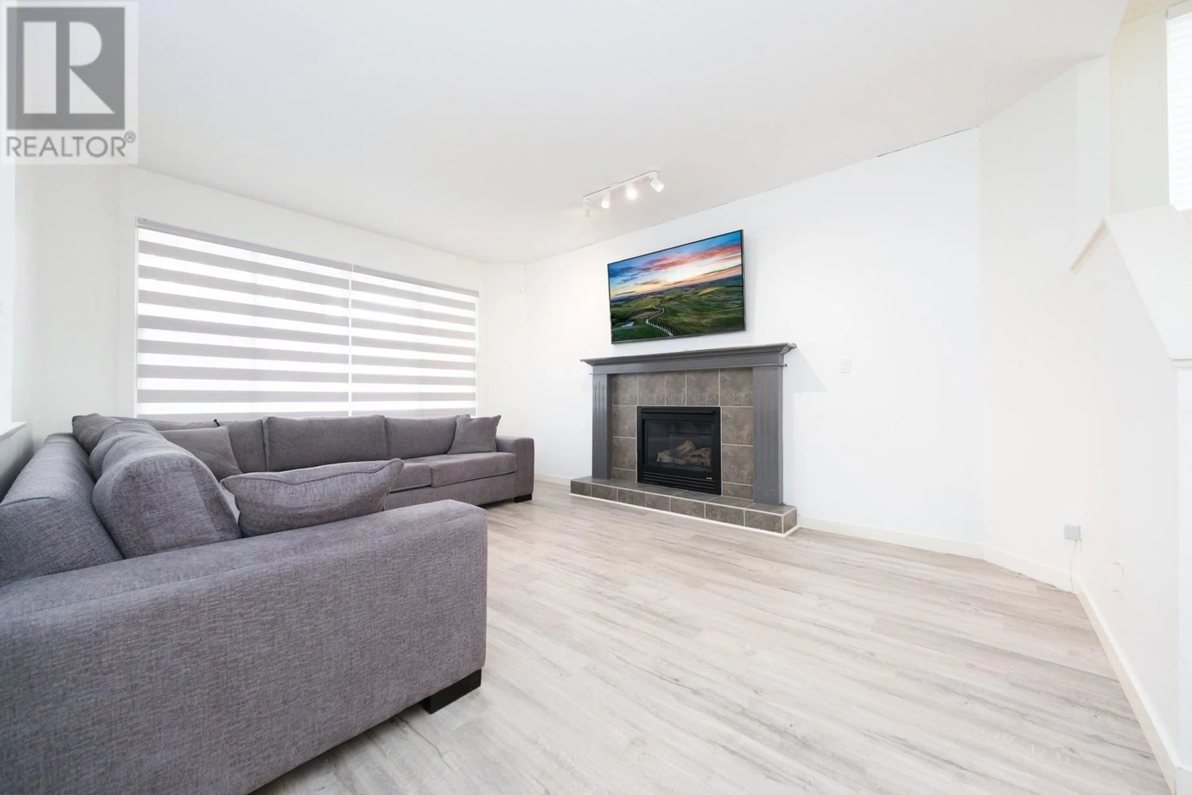 Living room with furniture, wood/laminate floor for 24342 102B AVENUE, Maple Ridge British Columbia V2W1Y2
