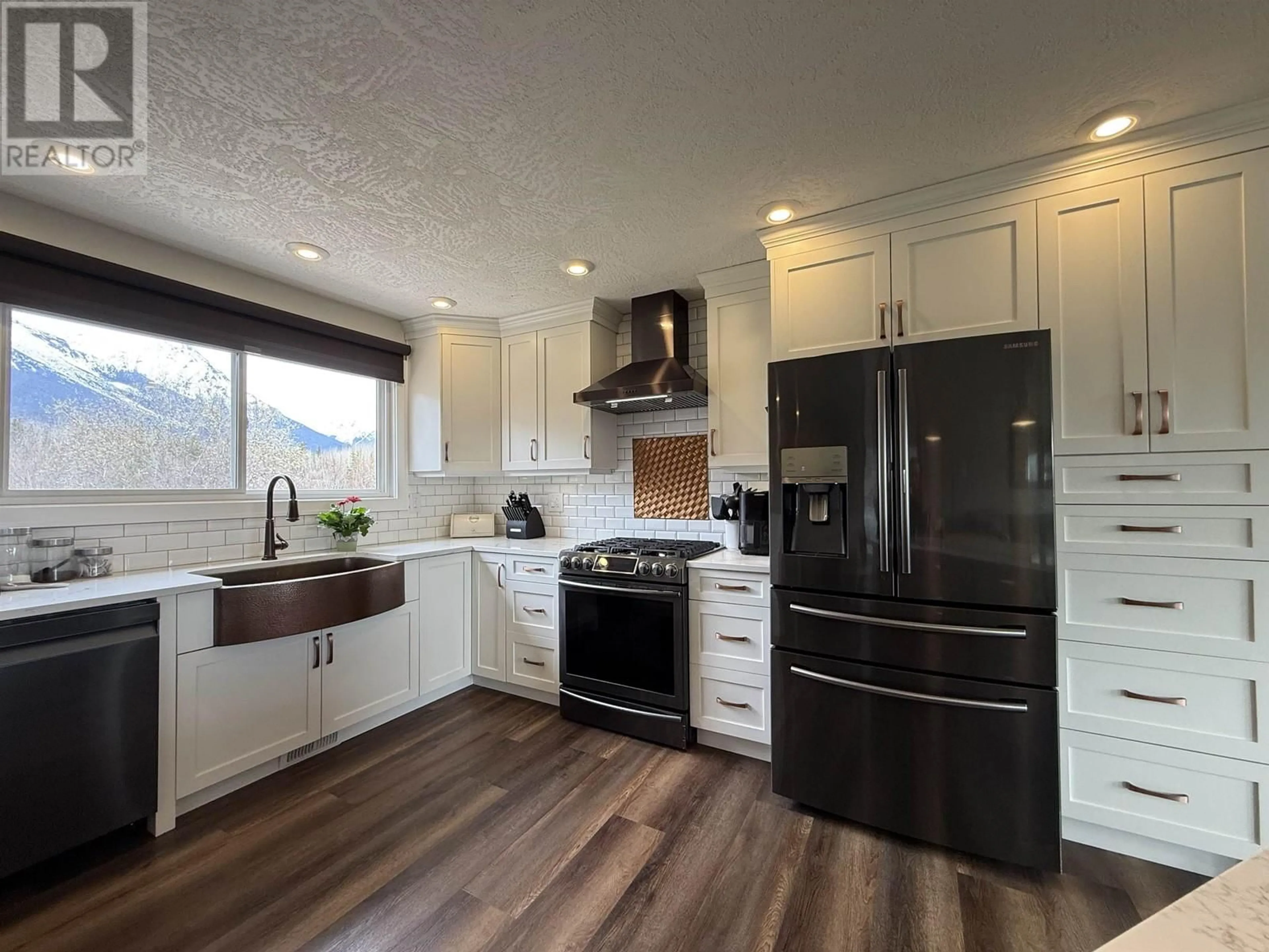 Open concept kitchen, wood/laminate floor for 4690 SIMCOE LOOP, Smithers British Columbia V0J2N2