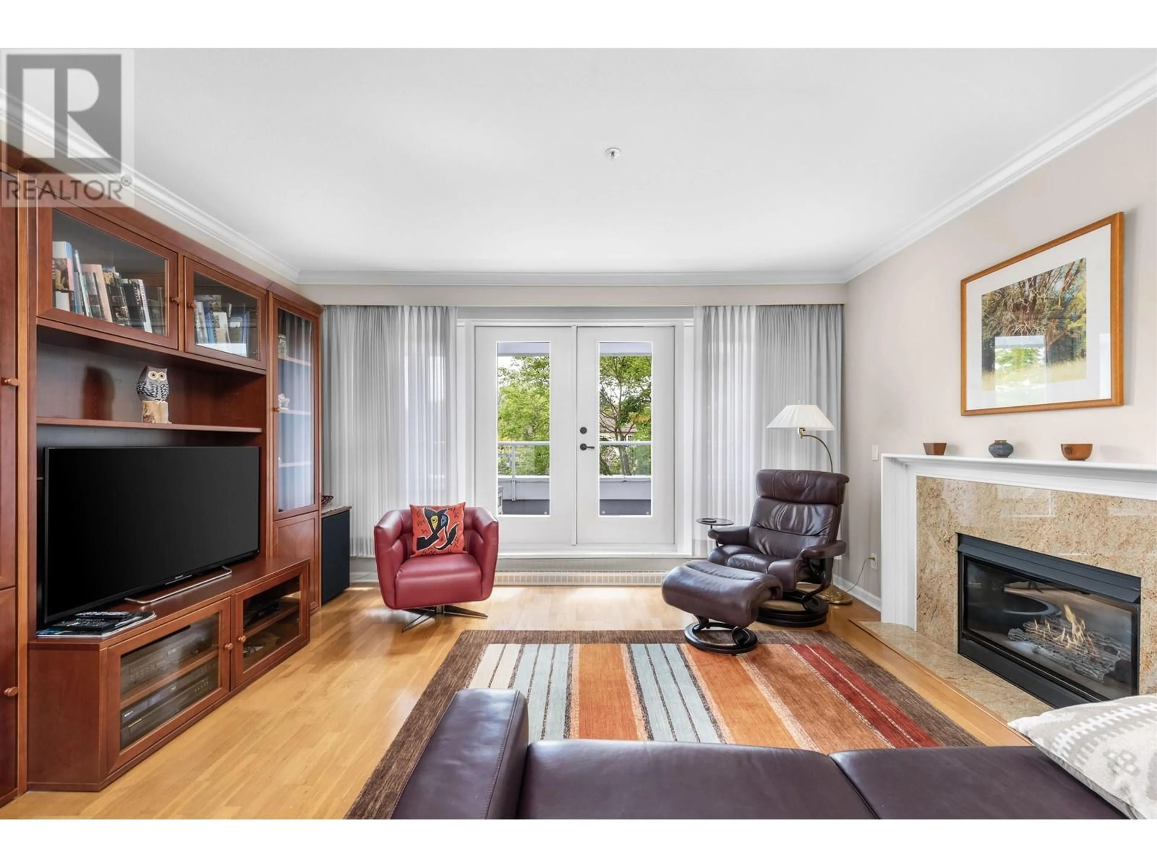 Living room with furniture, wood/laminate floor for 202 - 3189 CAMOSUN STREET, Vancouver British Columbia V6R3X2
