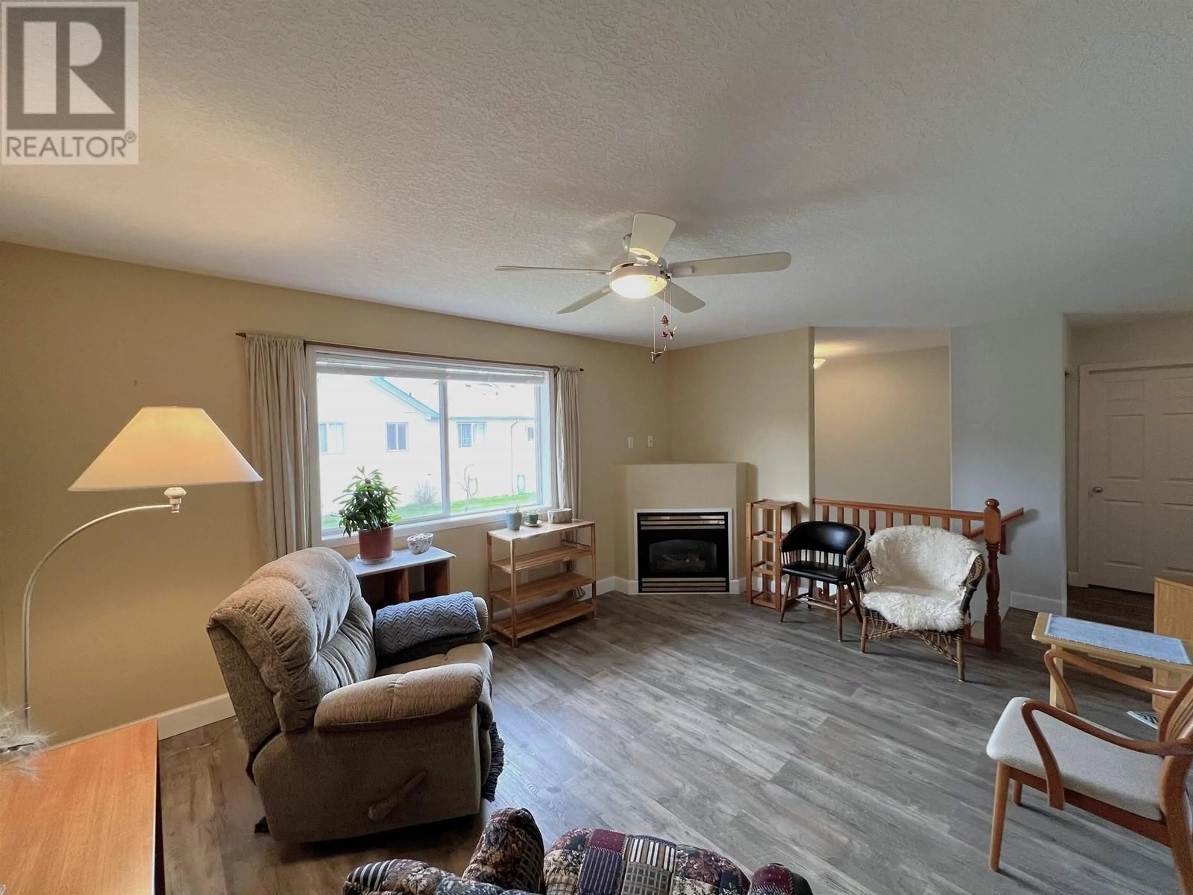 Living room with furniture, wood/laminate floor for 116 - 6807 WESTGATE AVENUE, Prince George British Columbia V2N5T8