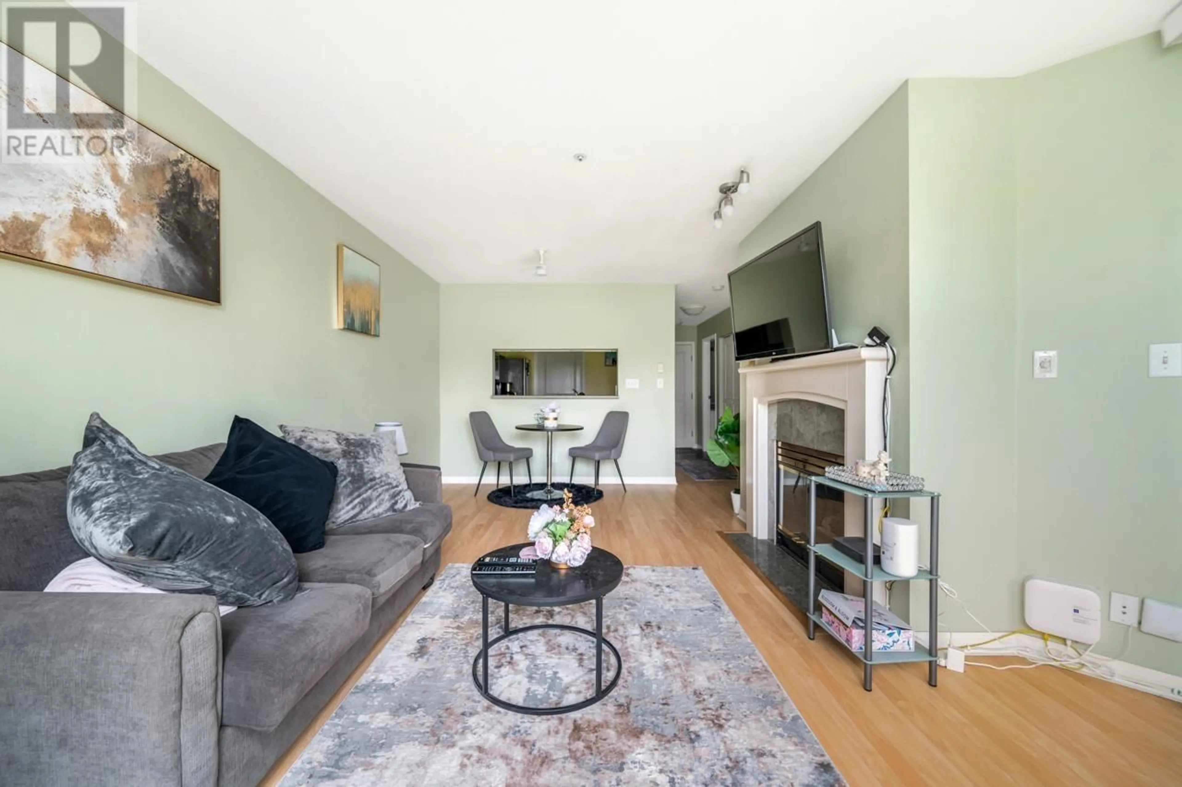 Living room with furniture, wood/laminate floor for 207 - 8450 JELLICOE STREET, Vancouver British Columbia V5S4S9