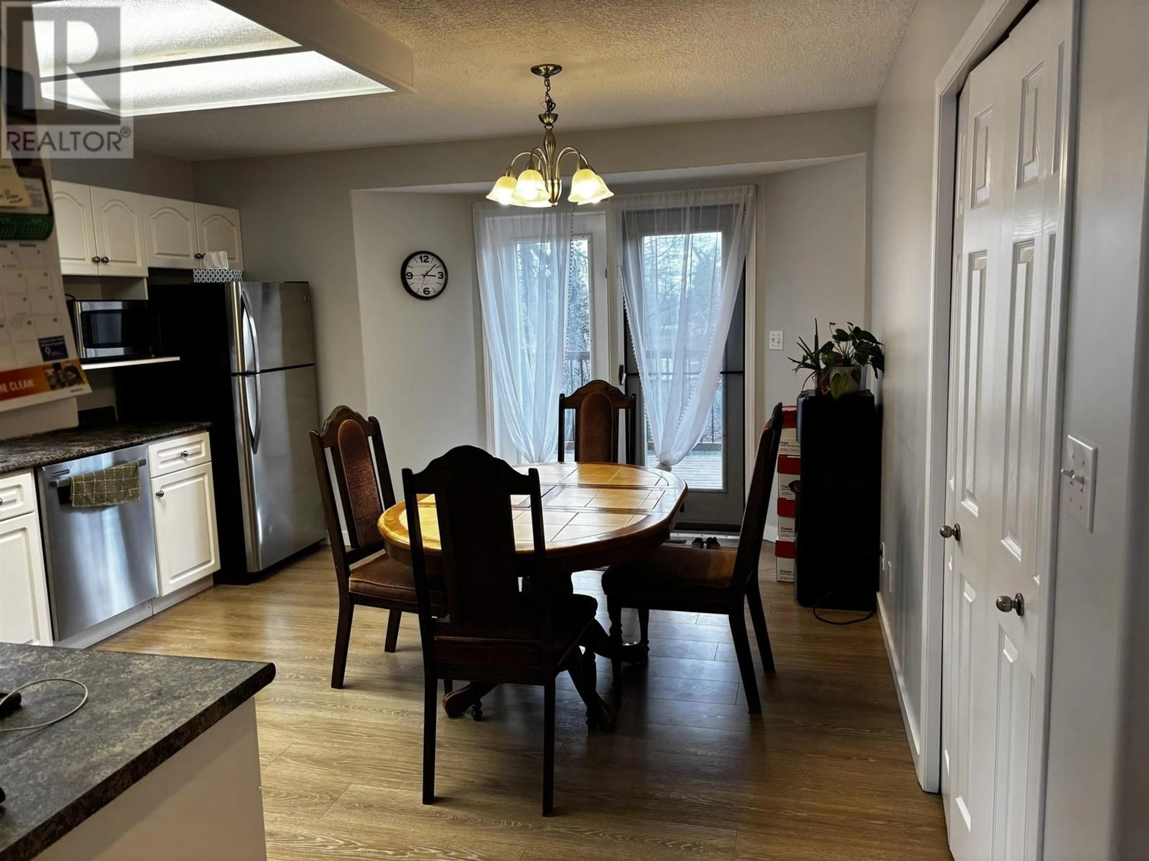 Dining room, wood/laminate floor for 9011 99 AVENUE, Fort St. John British Columbia V1J5S2