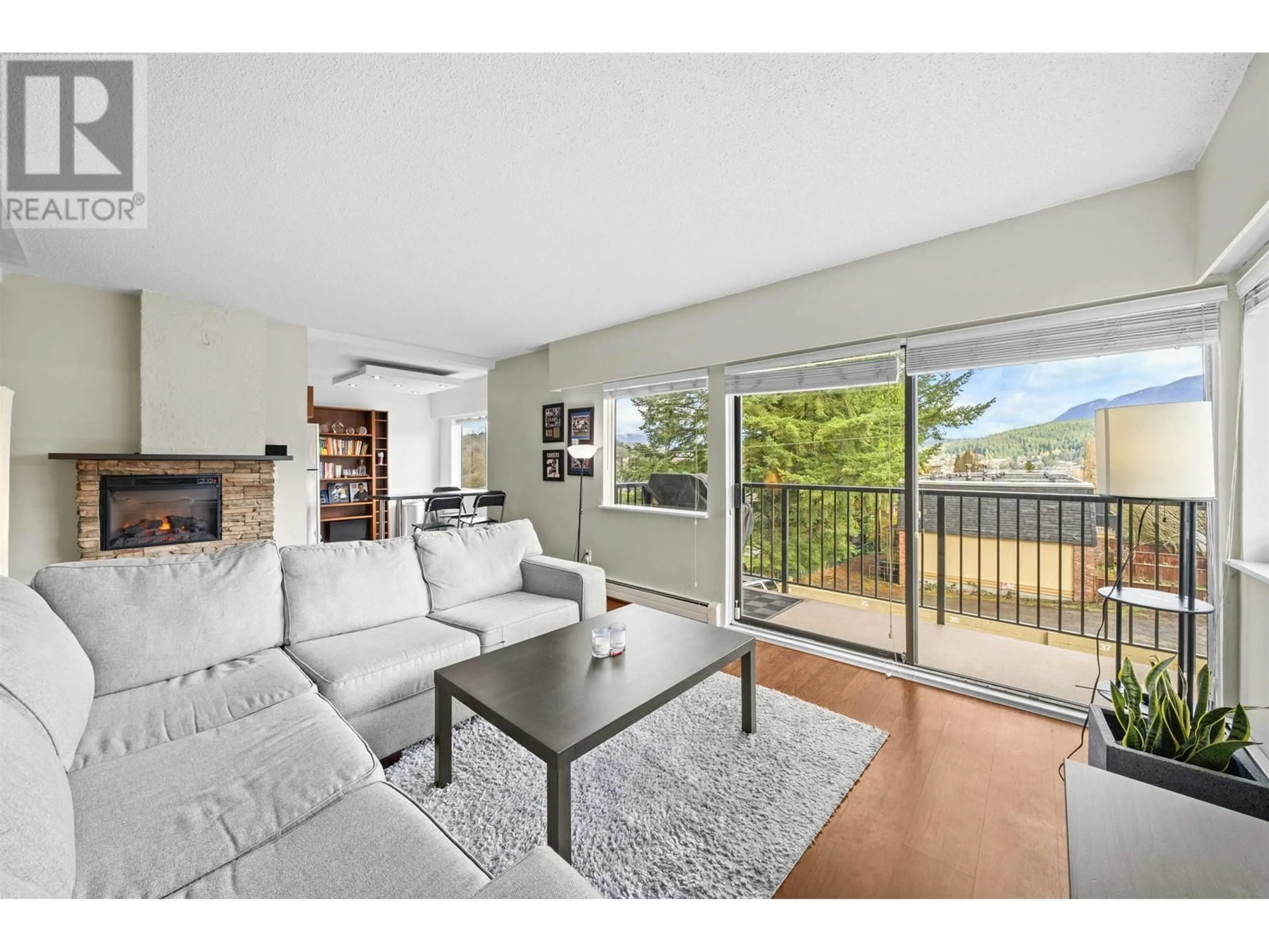 Living room with furniture, wood/laminate floor for 110 - 195 MARY STREET, Port Moody British Columbia V3H2P1
