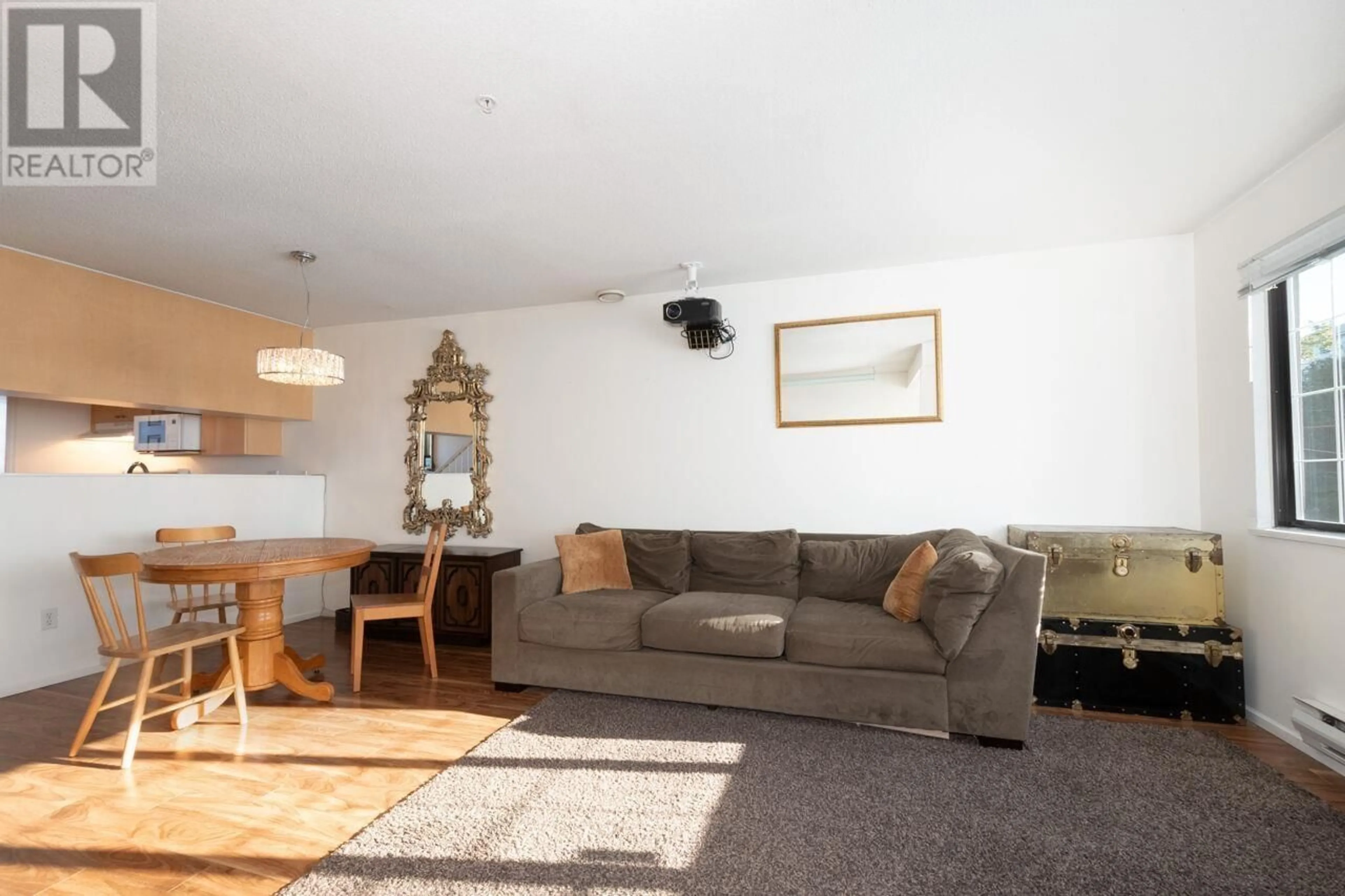 Living room with furniture, wood/laminate floor for 203 - 3368 MAIN STREET, Vancouver British Columbia V5V3M7