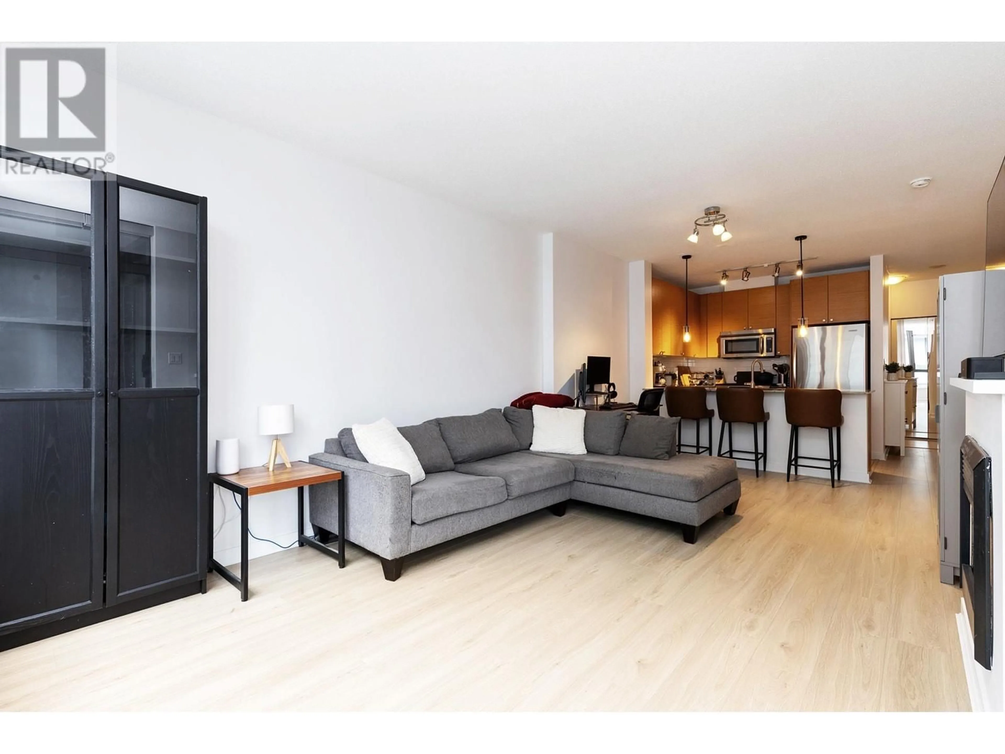 Living room with furniture, wood/laminate floor for 509 - 400 CAPILANO ROAD, Port Moody British Columbia V3H0E1