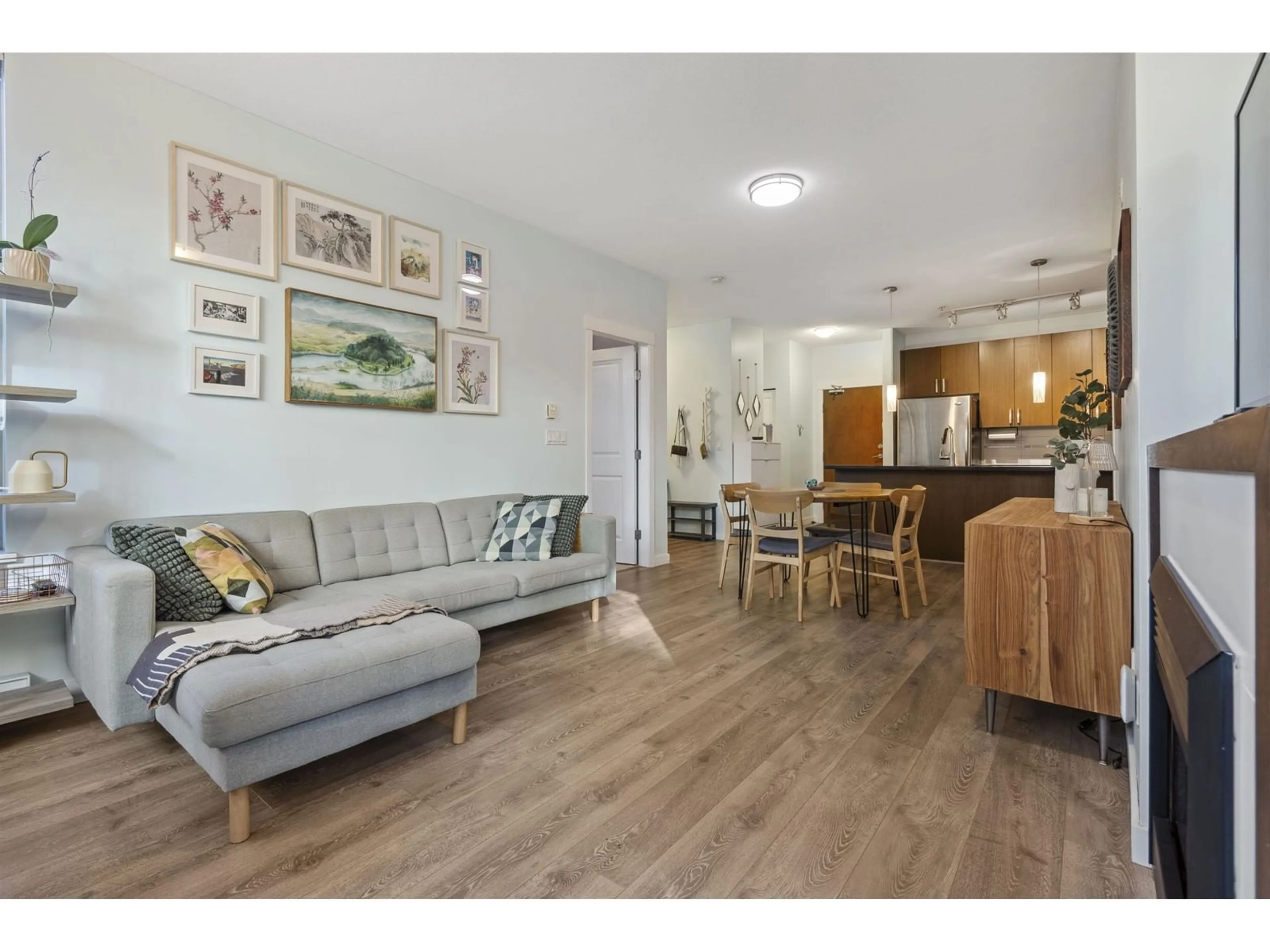 Living room with furniture, wood/laminate floor for 117 - 15918 26, Surrey British Columbia V3Z5K3