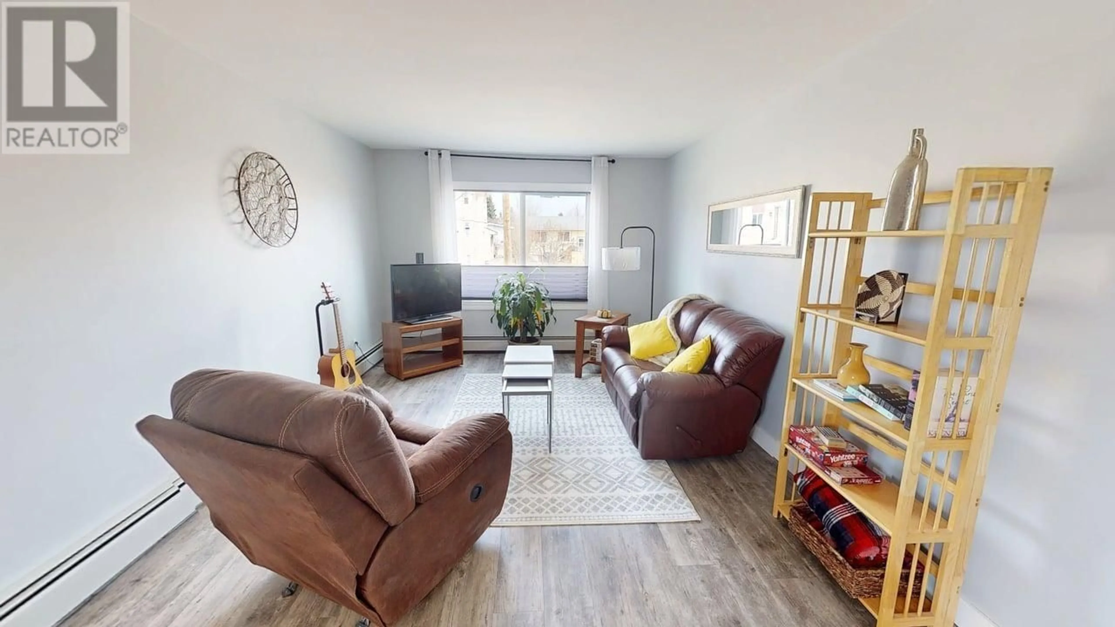 Living room with furniture, wood/laminate floor for 209 - 10216 102 AVENUE, Fort St. John British Columbia V1J2E5
