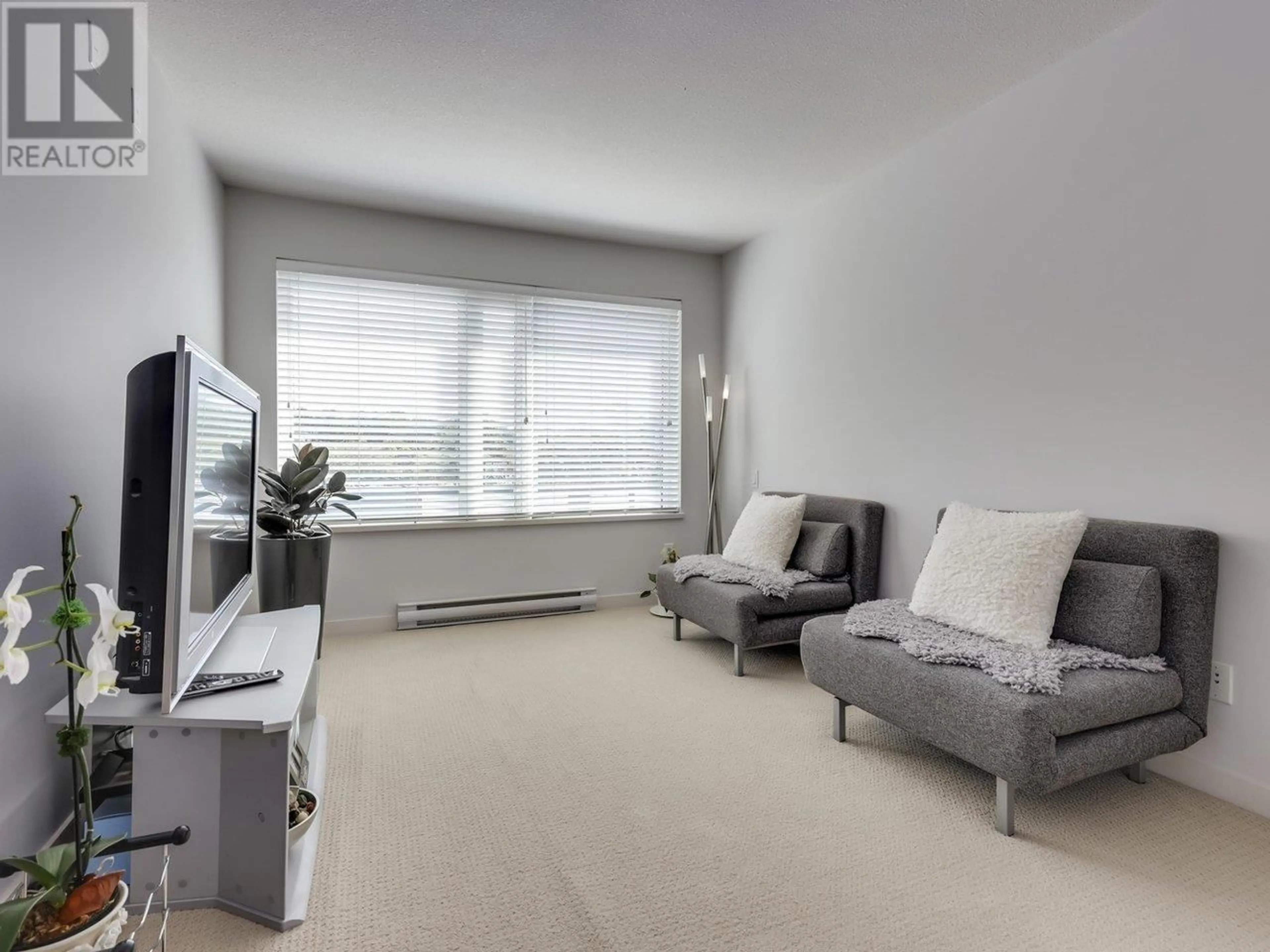Living room with furniture, unknown for 304 - 1673 LLOYD AVENUE, North Vancouver British Columbia V7P0A9