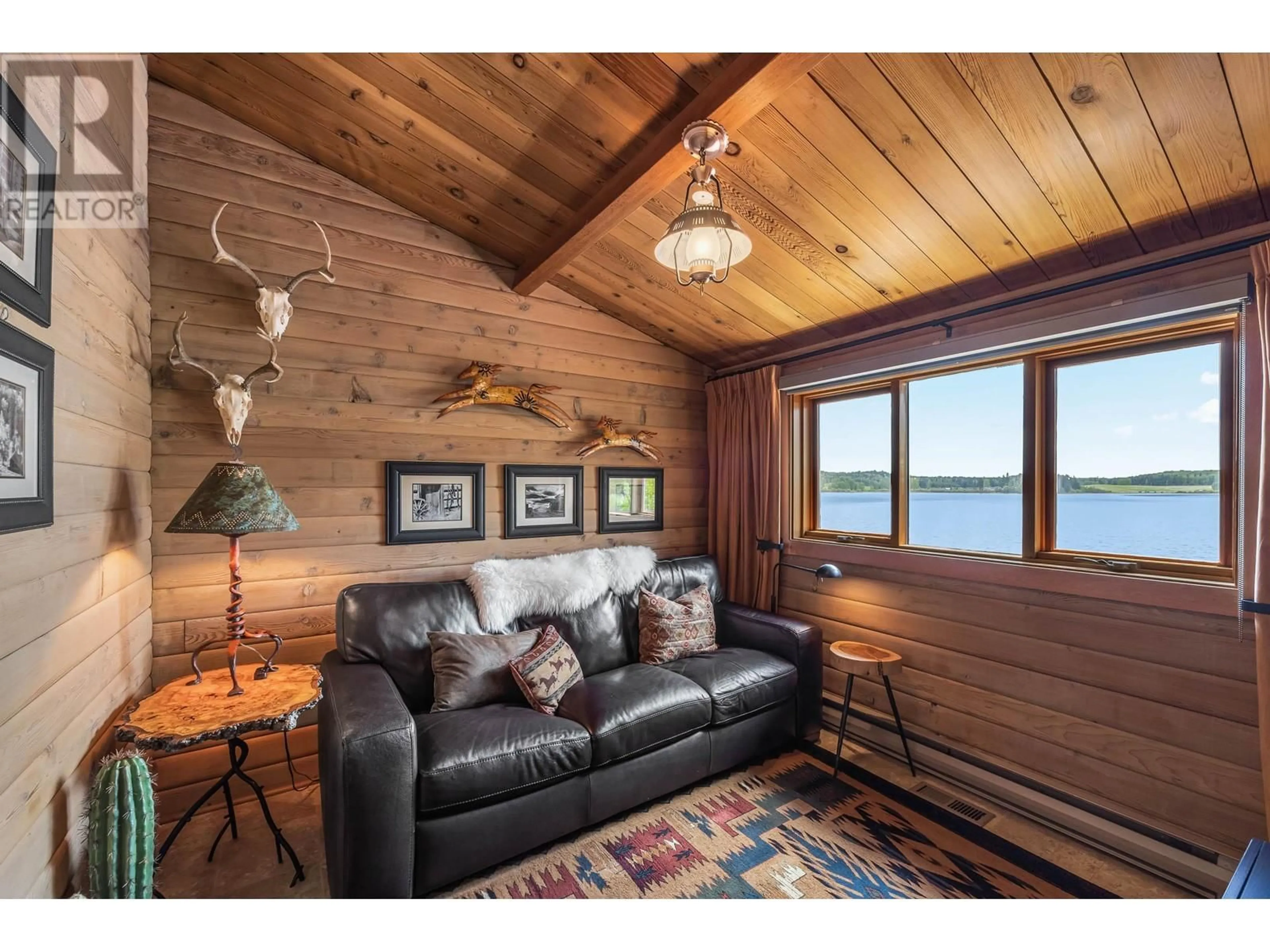 Living room with furniture, wood/laminate floor for 7315 SHERTENLIB ROAD, Bridge Lake British Columbia V0K1X2