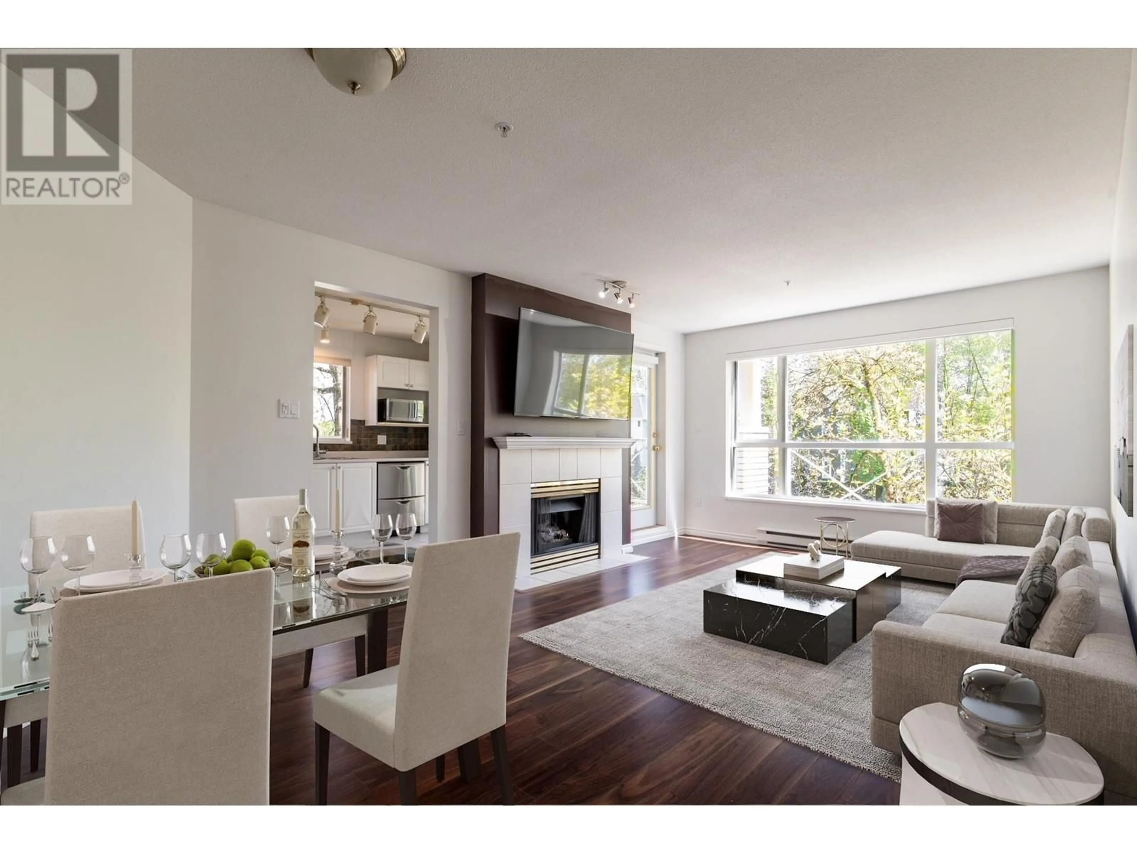 Living room with furniture, wood/laminate floor for 203 - 2559 PARKVIEW LANE, Port Coquitlam British Columbia V3C6M1