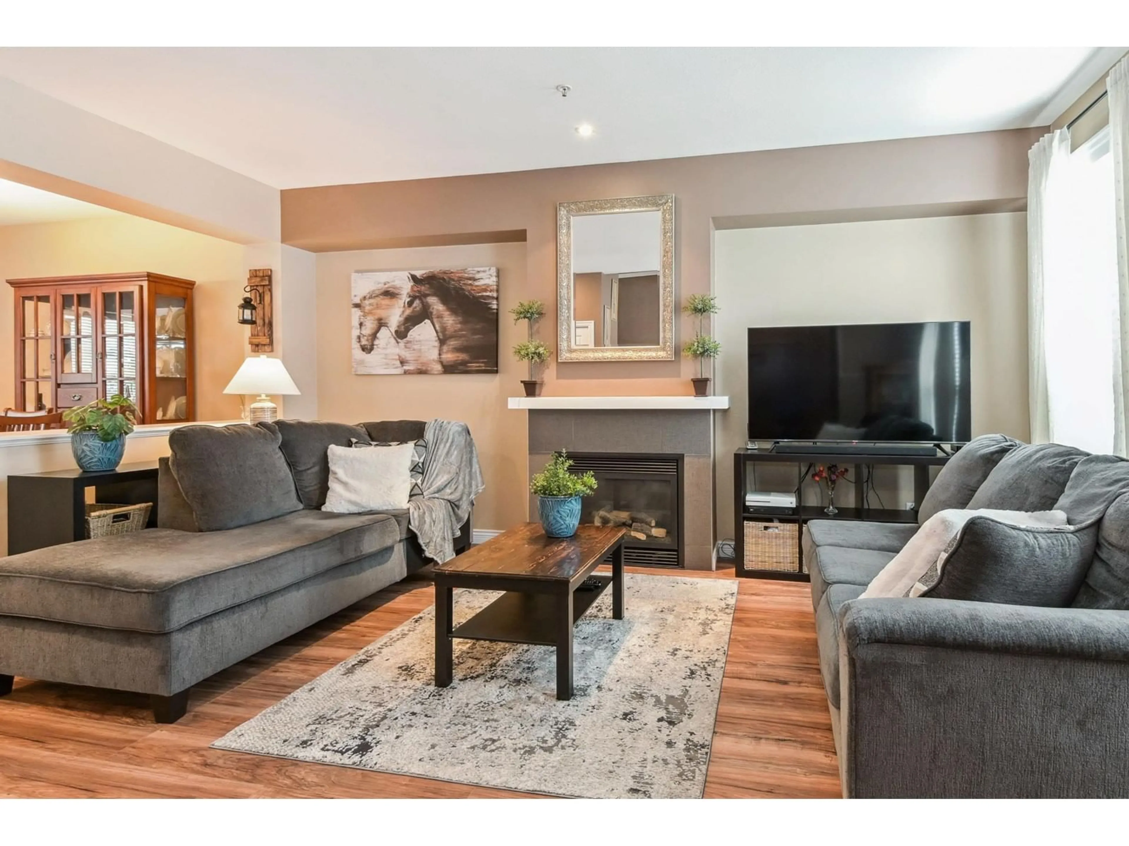 Living room with furniture, wood/laminate floor for 6953 208A, Langley British Columbia V2Y0G1