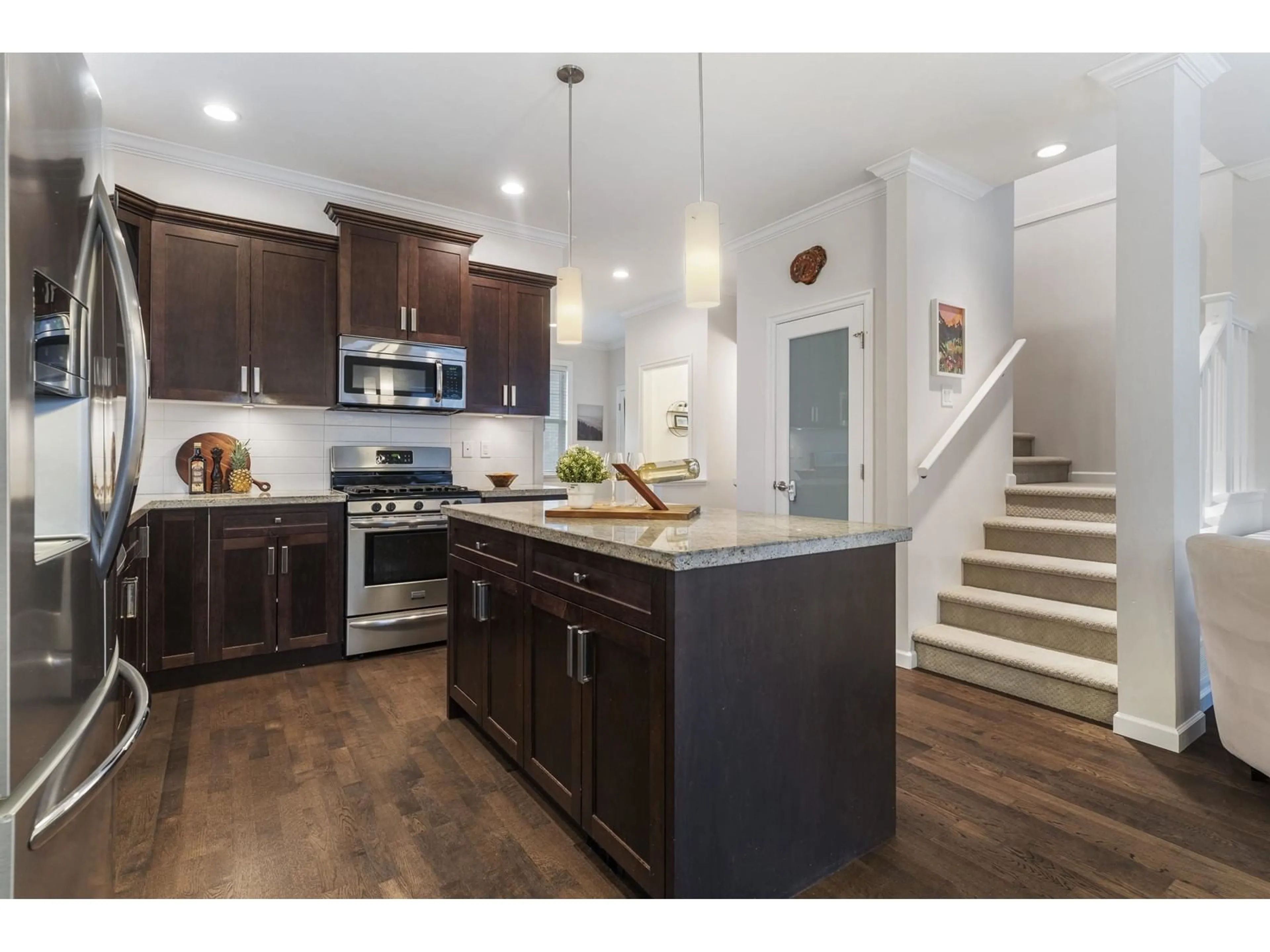 Open concept kitchen, wood/laminate floor for 6855 208A, Langley British Columbia V2Y0G2