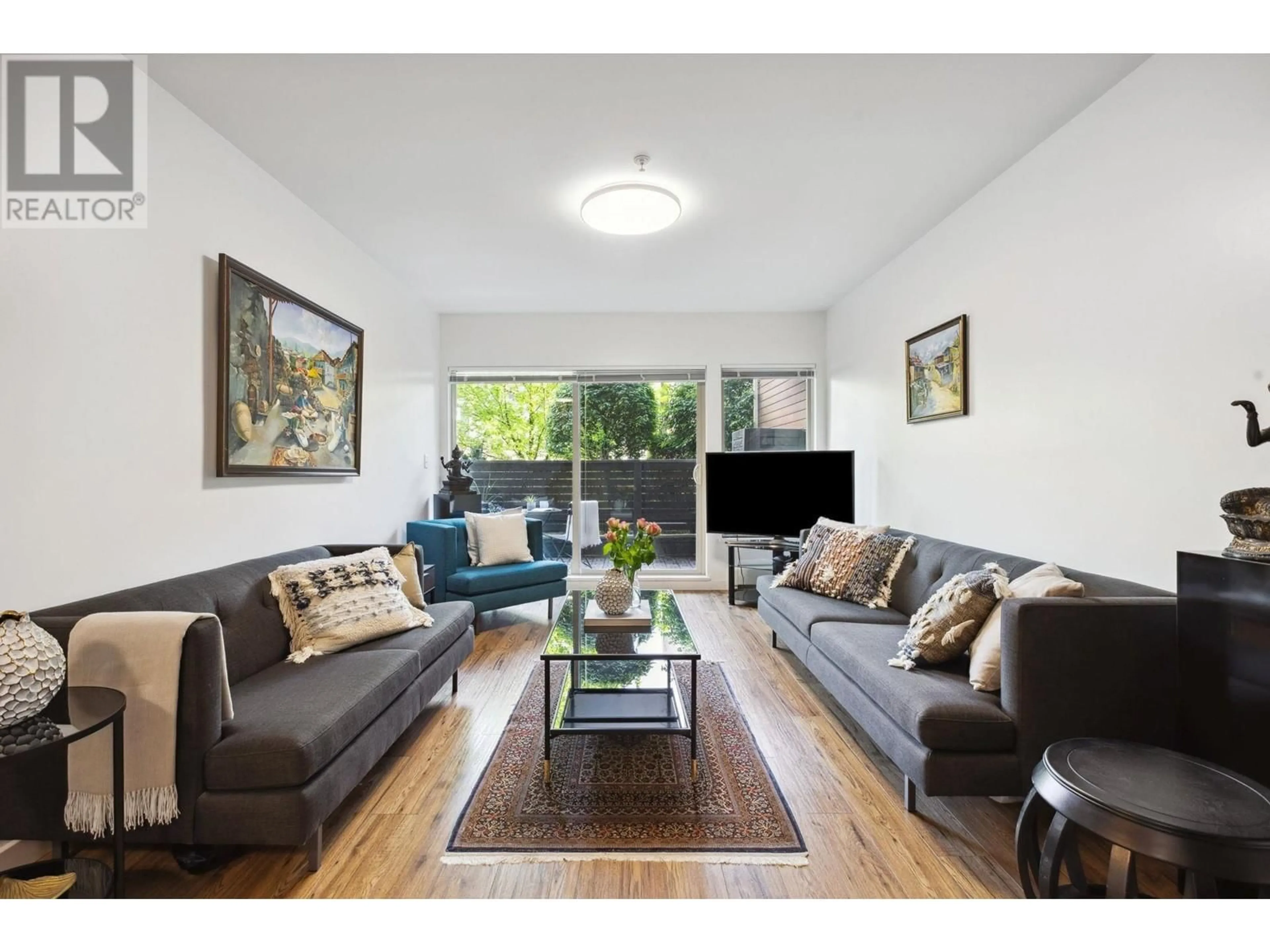 Living room with furniture, wood/laminate floor for 110 - 1033 ST. GEORGES AVENUE, North Vancouver British Columbia V7L3H5