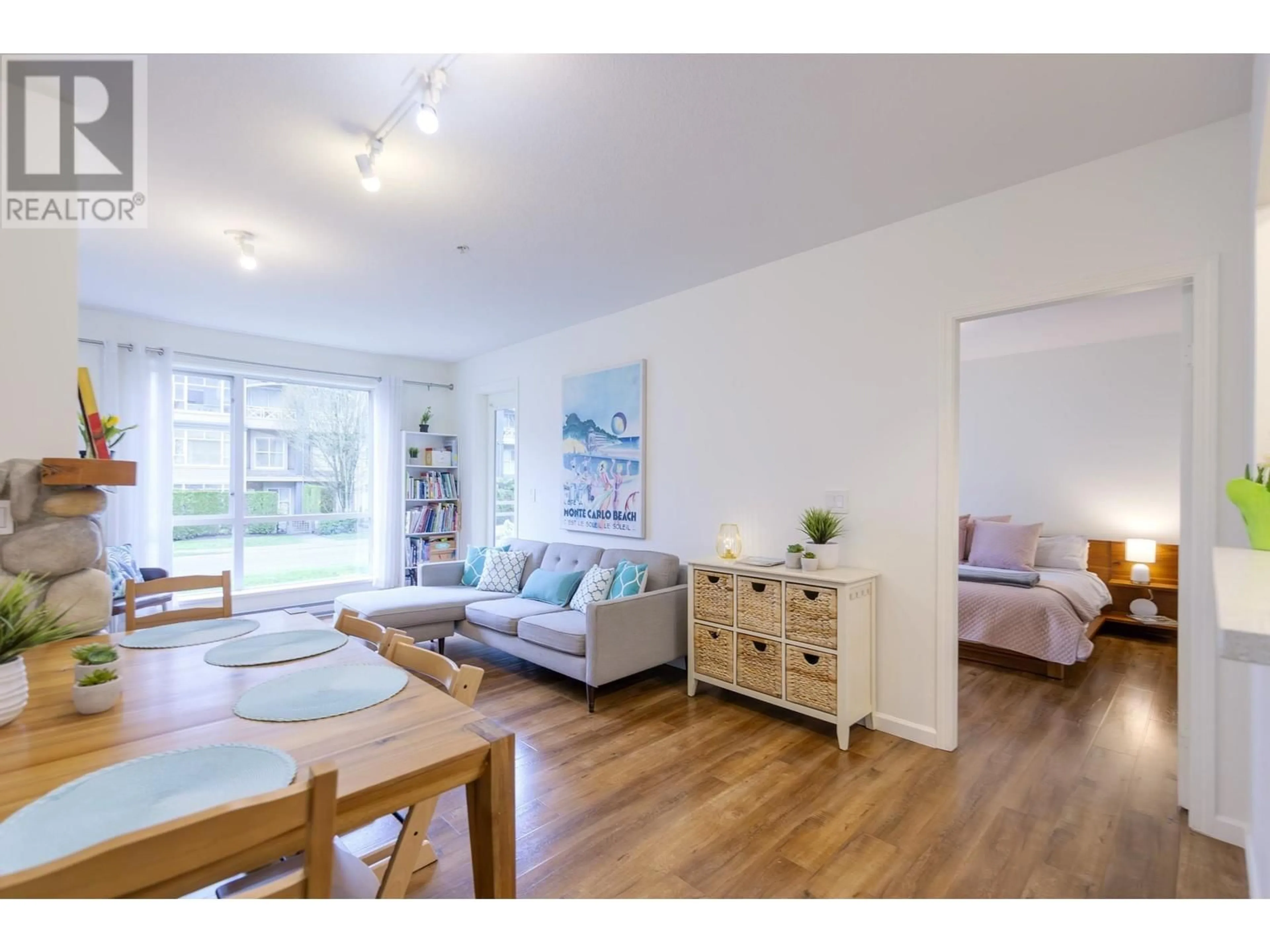 Living room with furniture, wood/laminate floor for 306 - 3608 DEERCREST COURT, North Vancouver British Columbia V7G2S8
