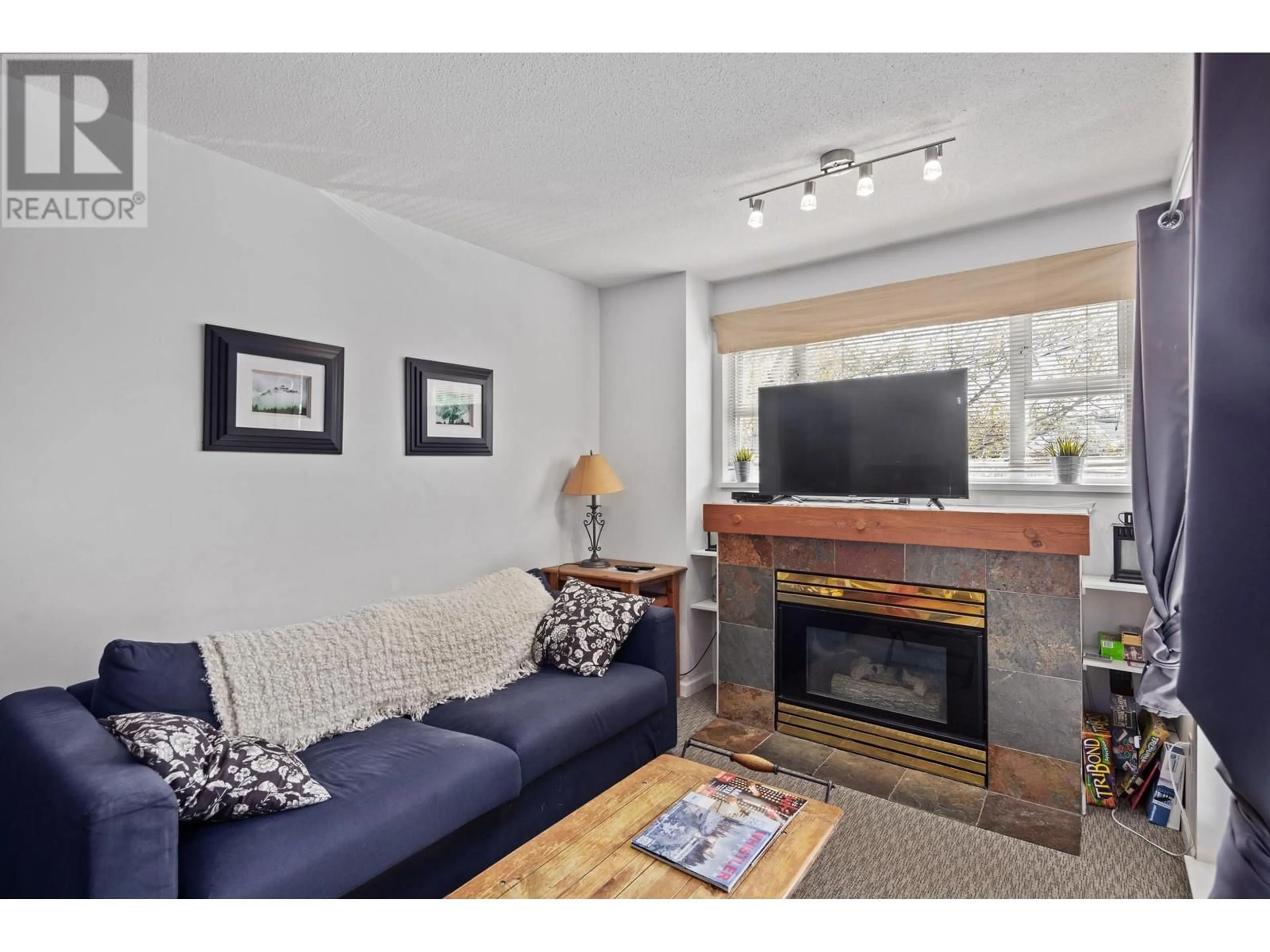 Living room with furniture, wood/laminate floor for 310 - 4360 LORIMER ROAD, Whistler British Columbia V8E1A0