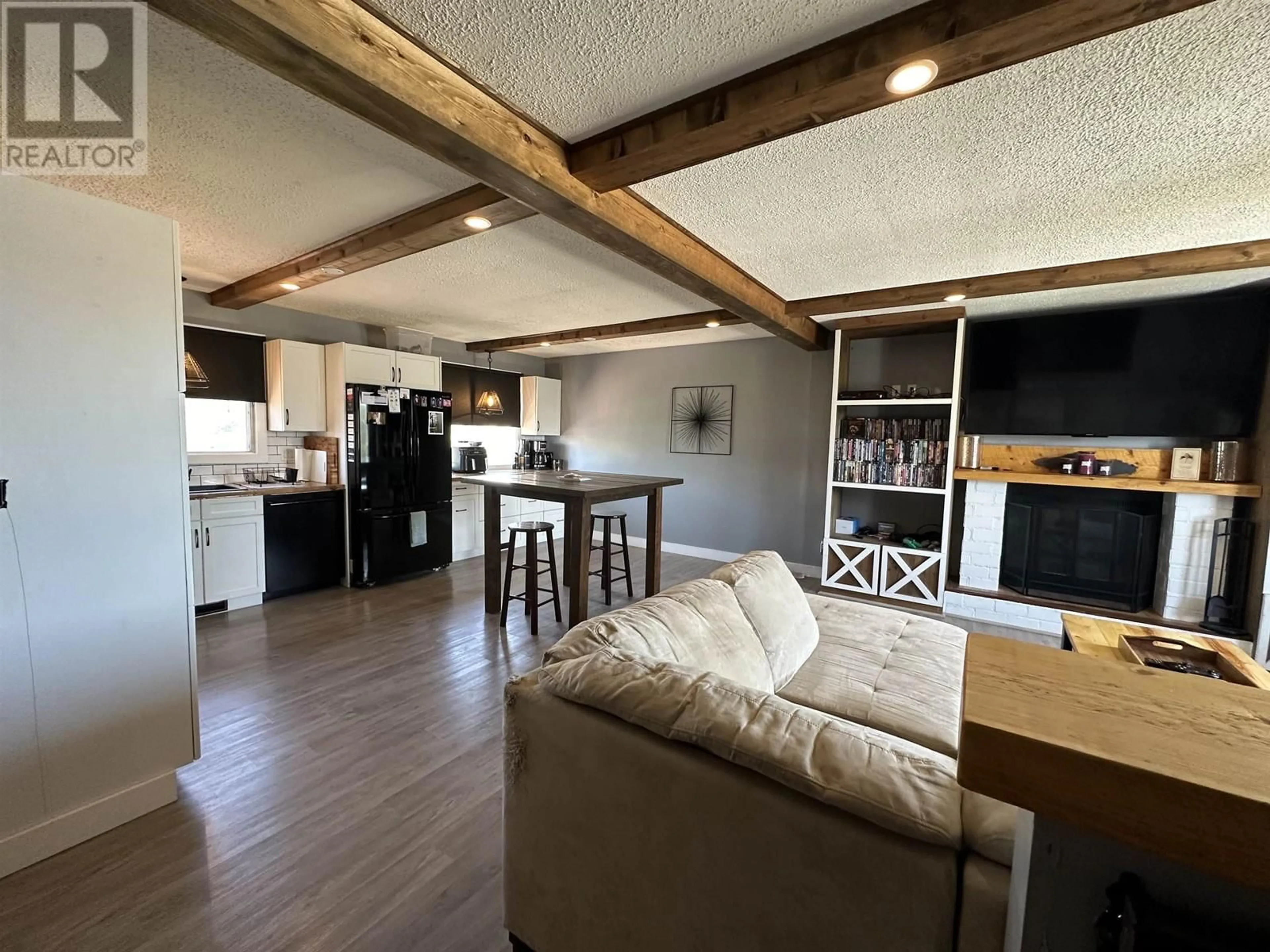 Open concept kitchen, wood/laminate floor for 8615 87 STREET, Fort St. John British Columbia V1J5T9