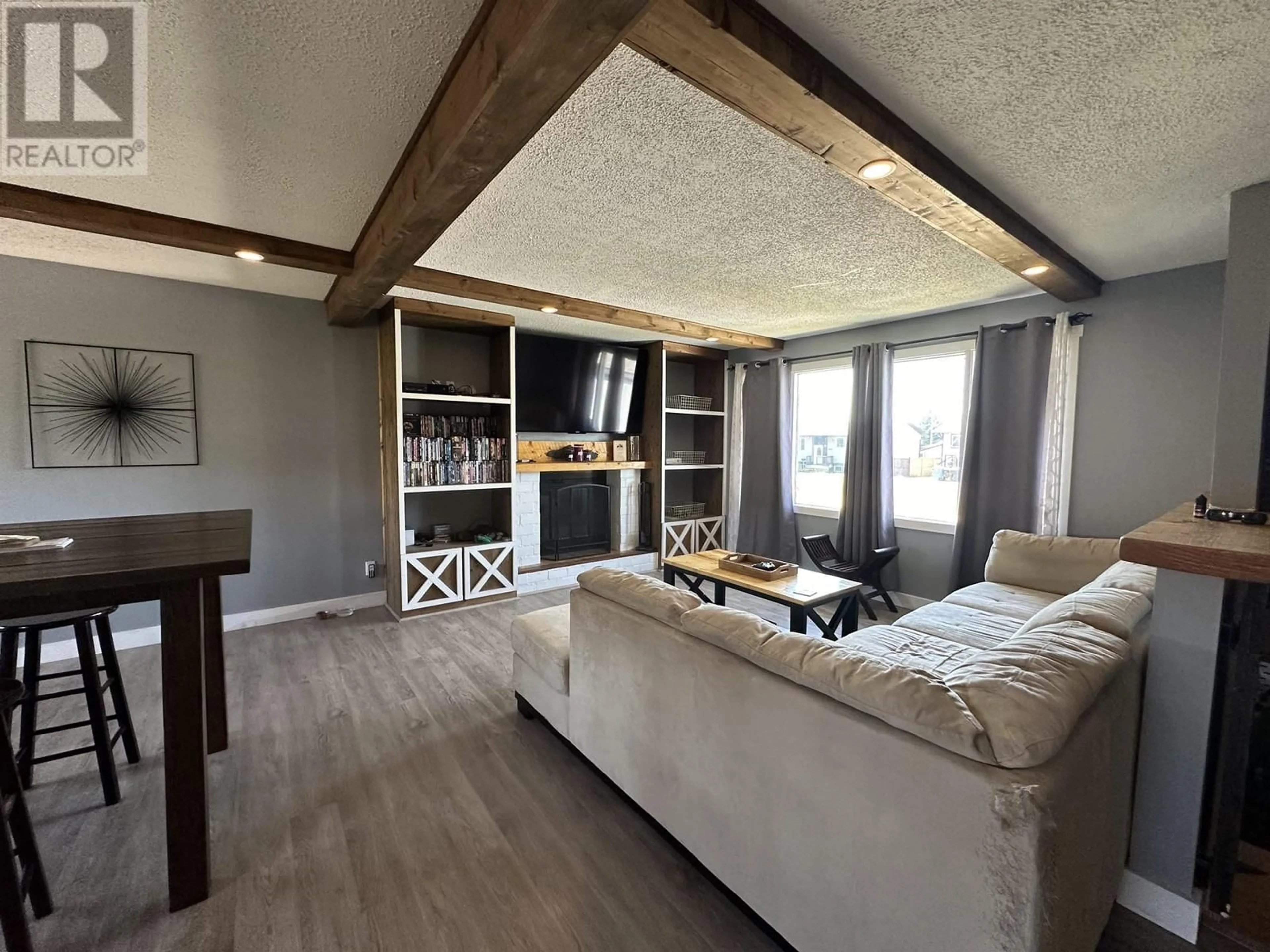 Living room with furniture, wood/laminate floor for 8615 87 STREET, Fort St. John British Columbia V1J5T9