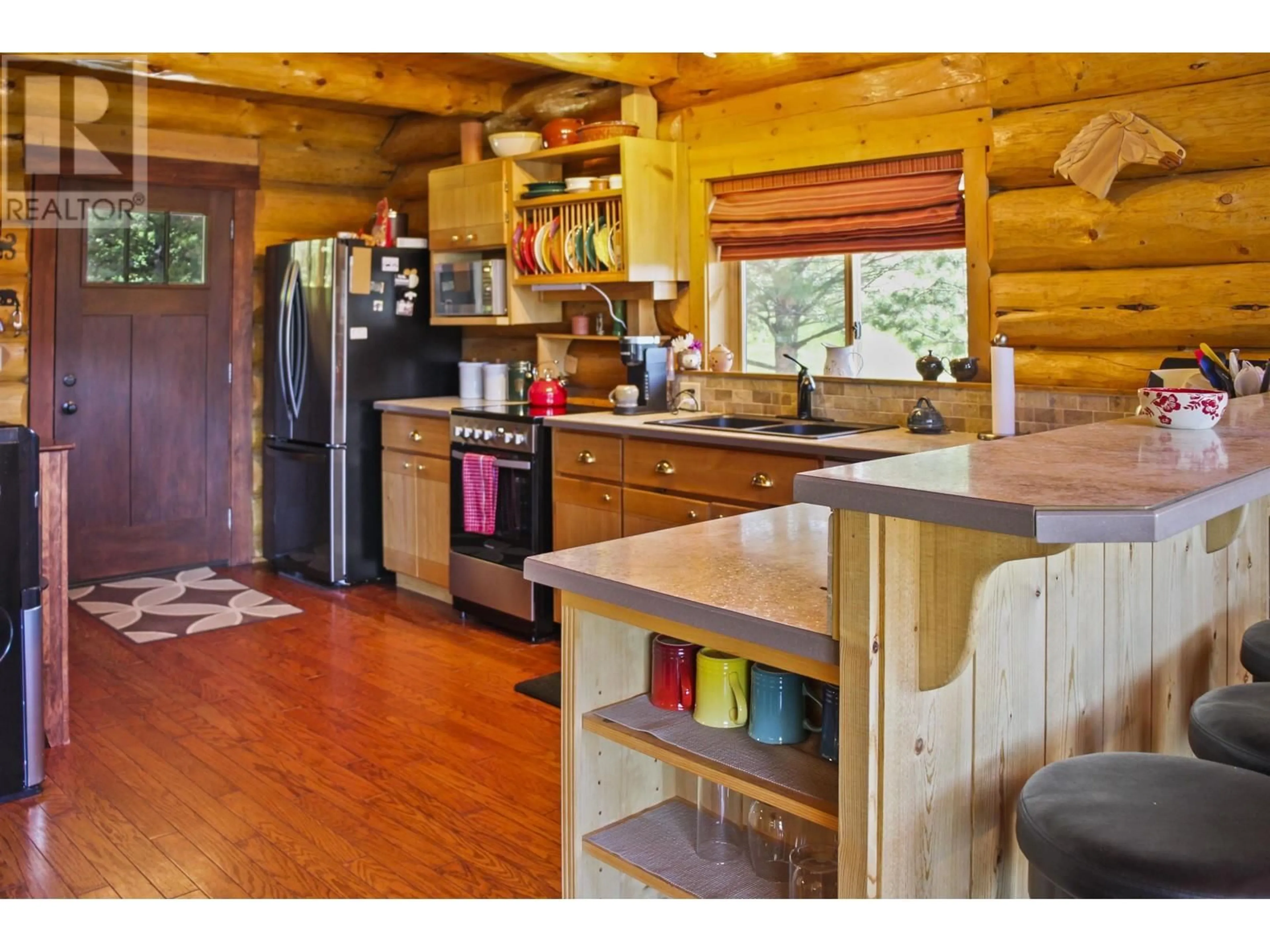 Rustic kitchen, wood/laminate floor for 7540 MCCARTHY ROAD, Bridge Lake British Columbia V0K1E0