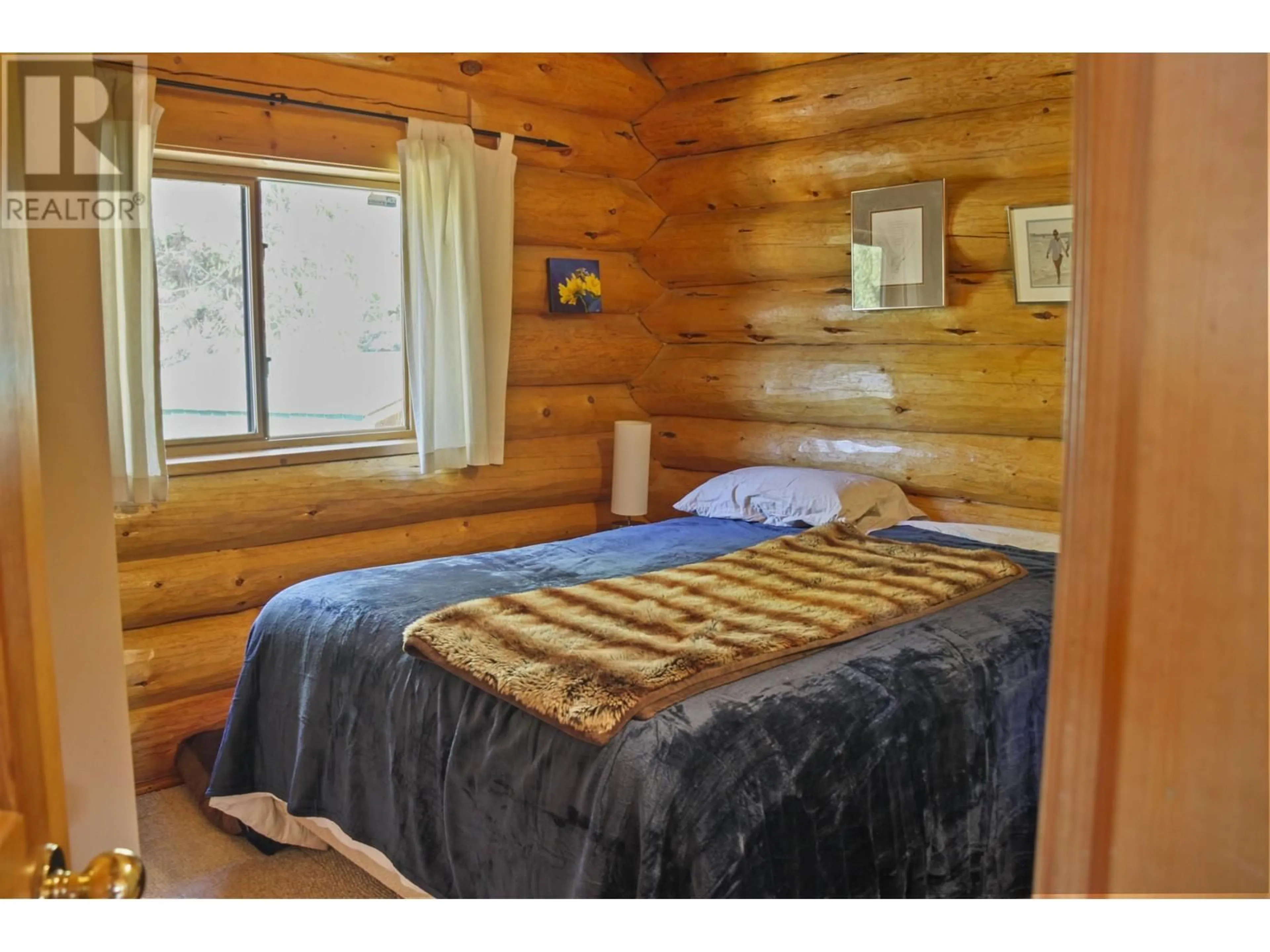 Bedroom with bed, wood/laminate floor for 7540 MCCARTHY ROAD, Bridge Lake British Columbia V0K1E0