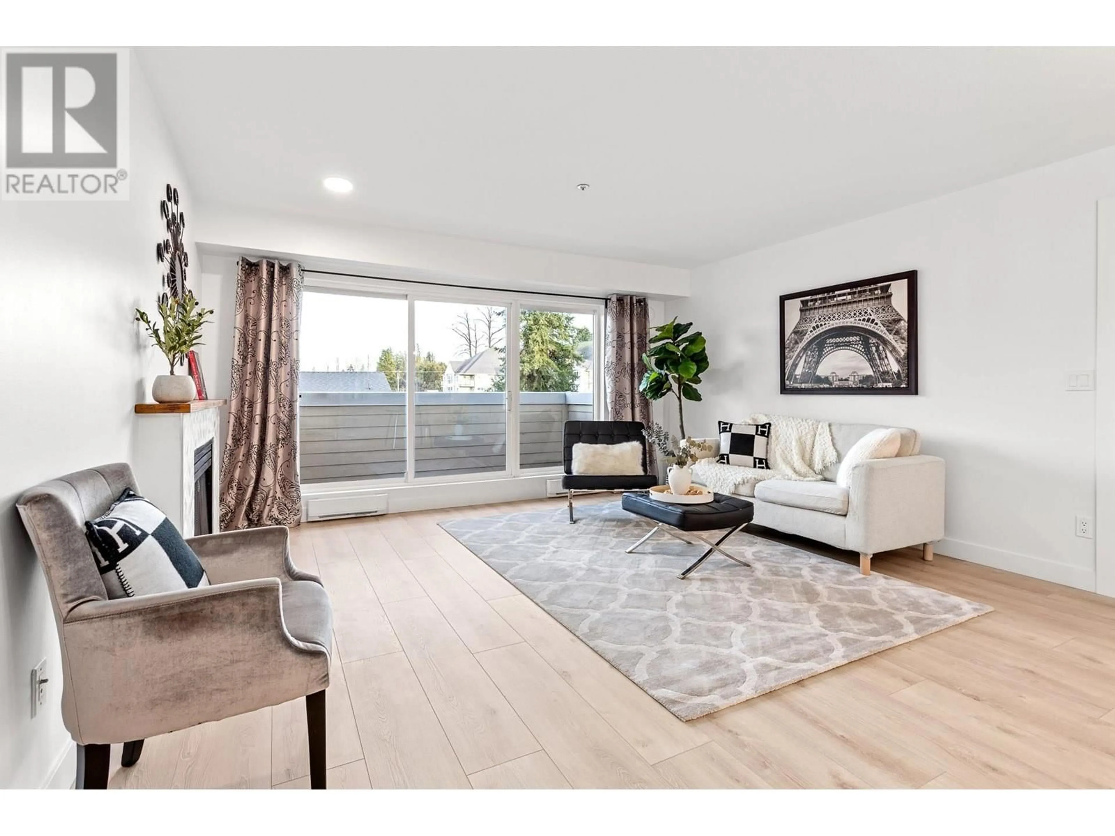 Living room with furniture, wood/laminate floor for 203 - 1570 PRAIRIE AVENUE, Port Coquitlam British Columbia V3B1T4