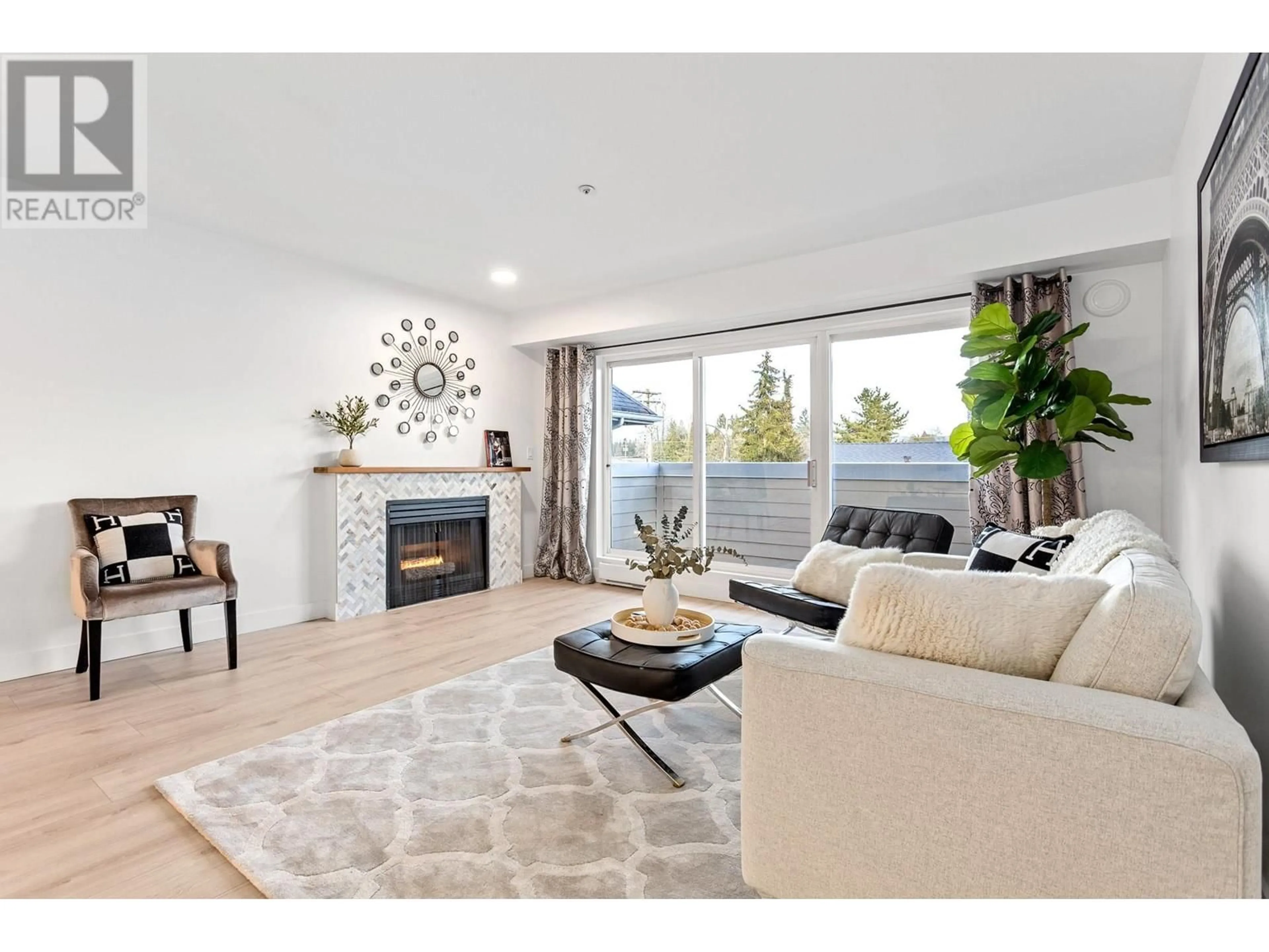 Living room with furniture, wood/laminate floor for 203 - 1570 PRAIRIE AVENUE, Port Coquitlam British Columbia V3B1T4