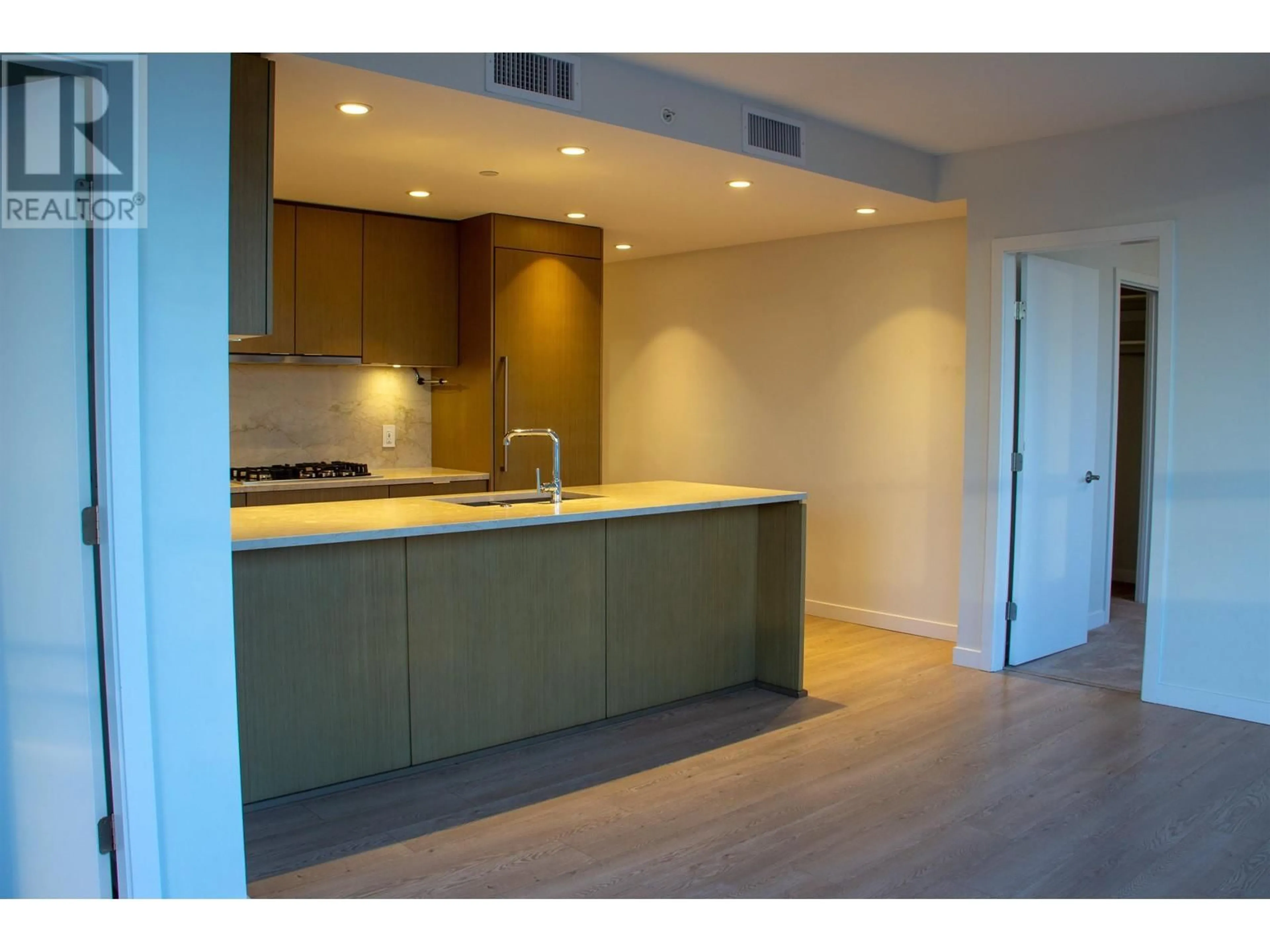 Open concept kitchen, wood/laminate floor for 803 - 112 13 STREET, North Vancouver British Columbia V7L0E4