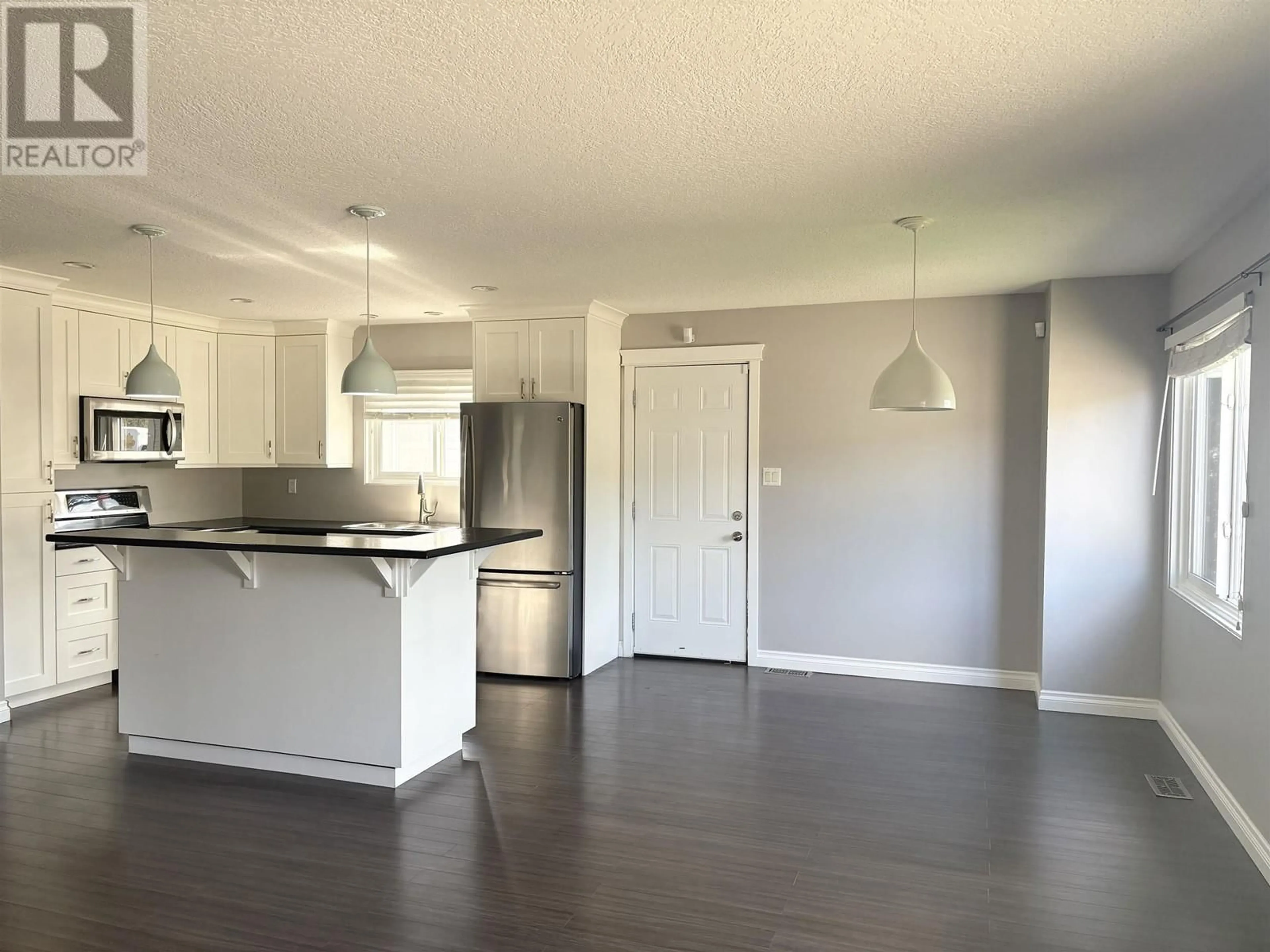 Open concept kitchen, wood/laminate floor for 2460 FOOT STREET, Prince George British Columbia V2N2Y4