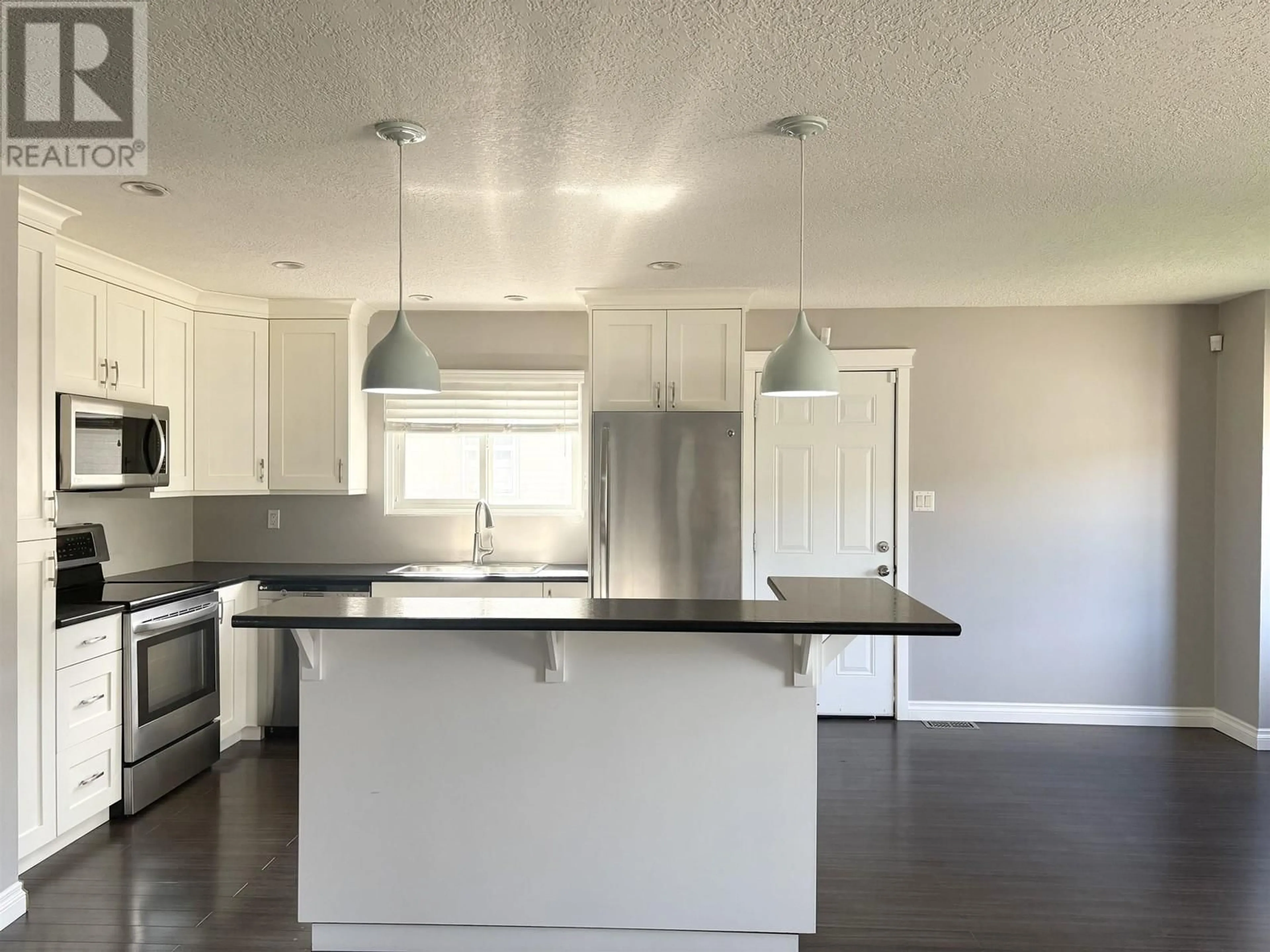 Open concept kitchen, wood/laminate floor for 2460 FOOT STREET, Prince George British Columbia V2N2Y4