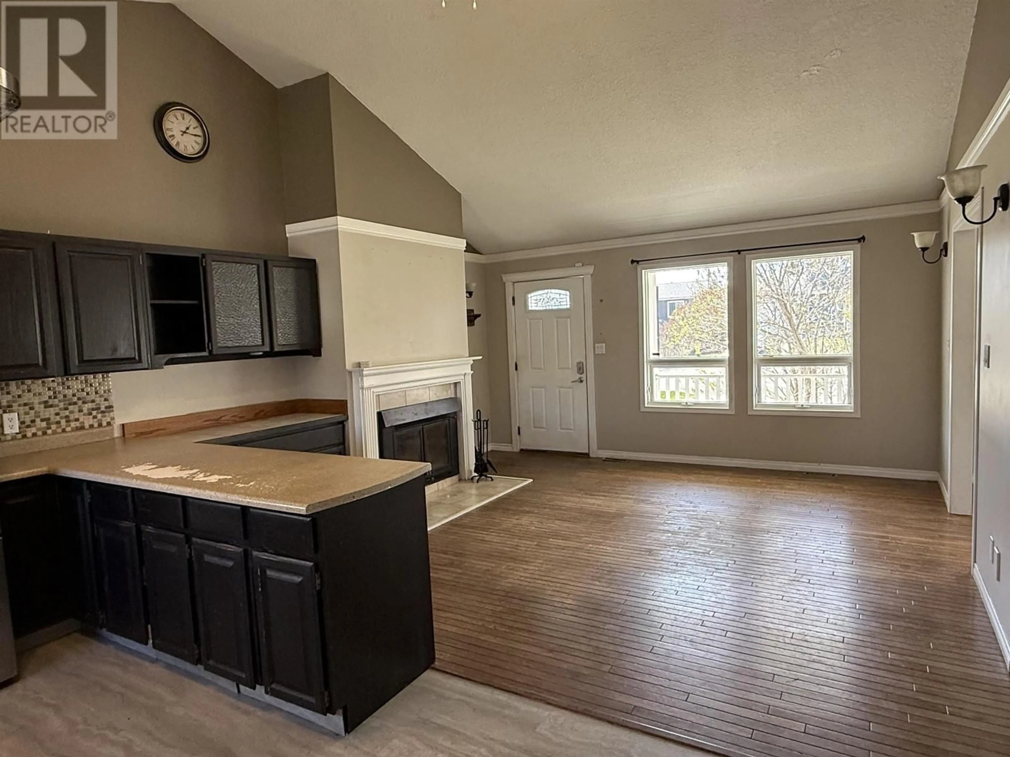 Open concept kitchen, wood/laminate floor for 9908 114 AVENUE, Fort St. John British Columbia V1J6L6