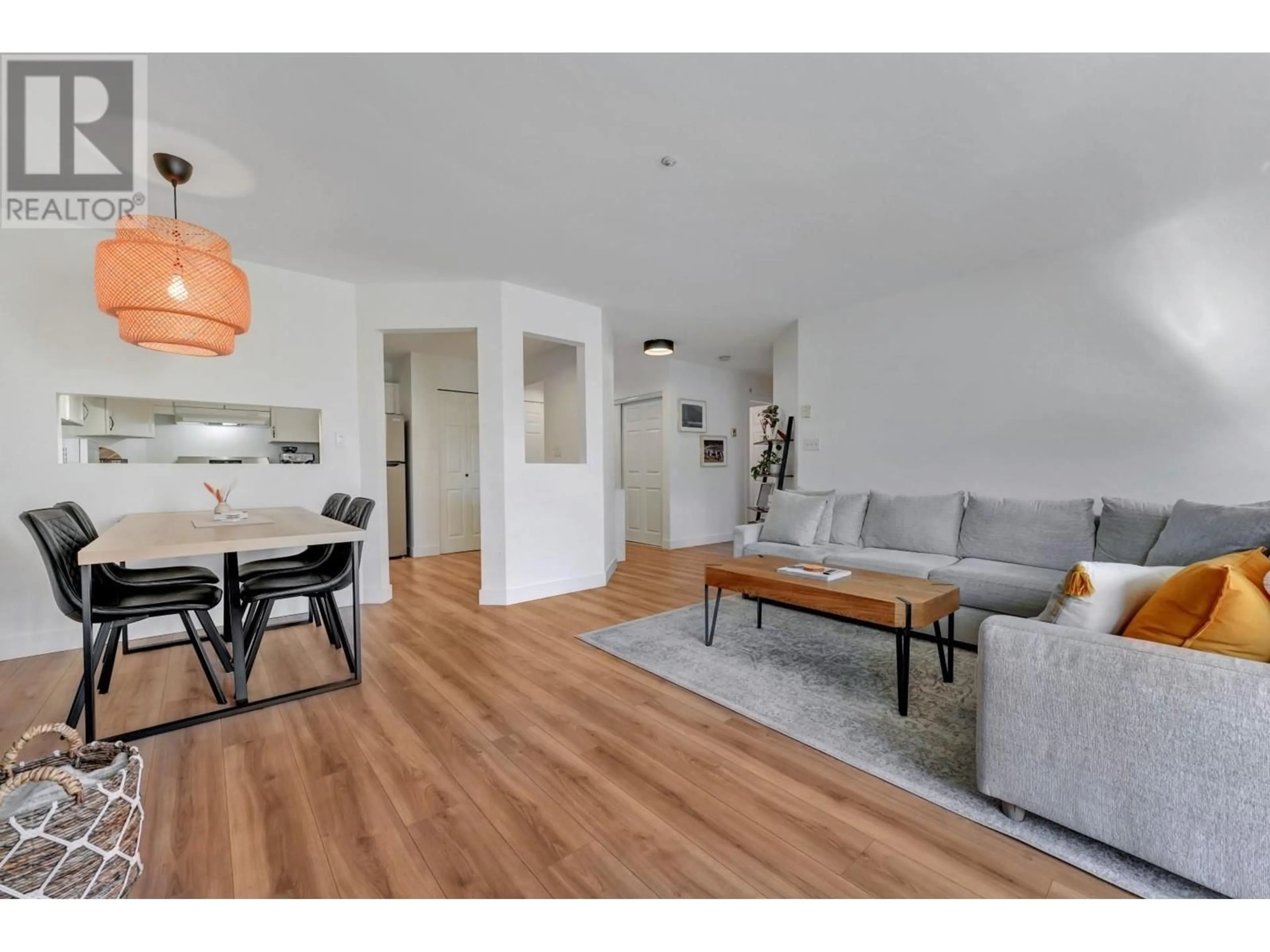 Living room with furniture, wood/laminate floor for 102 - 3400 MARINE DRIVE, Vancouver British Columbia V5S4P8