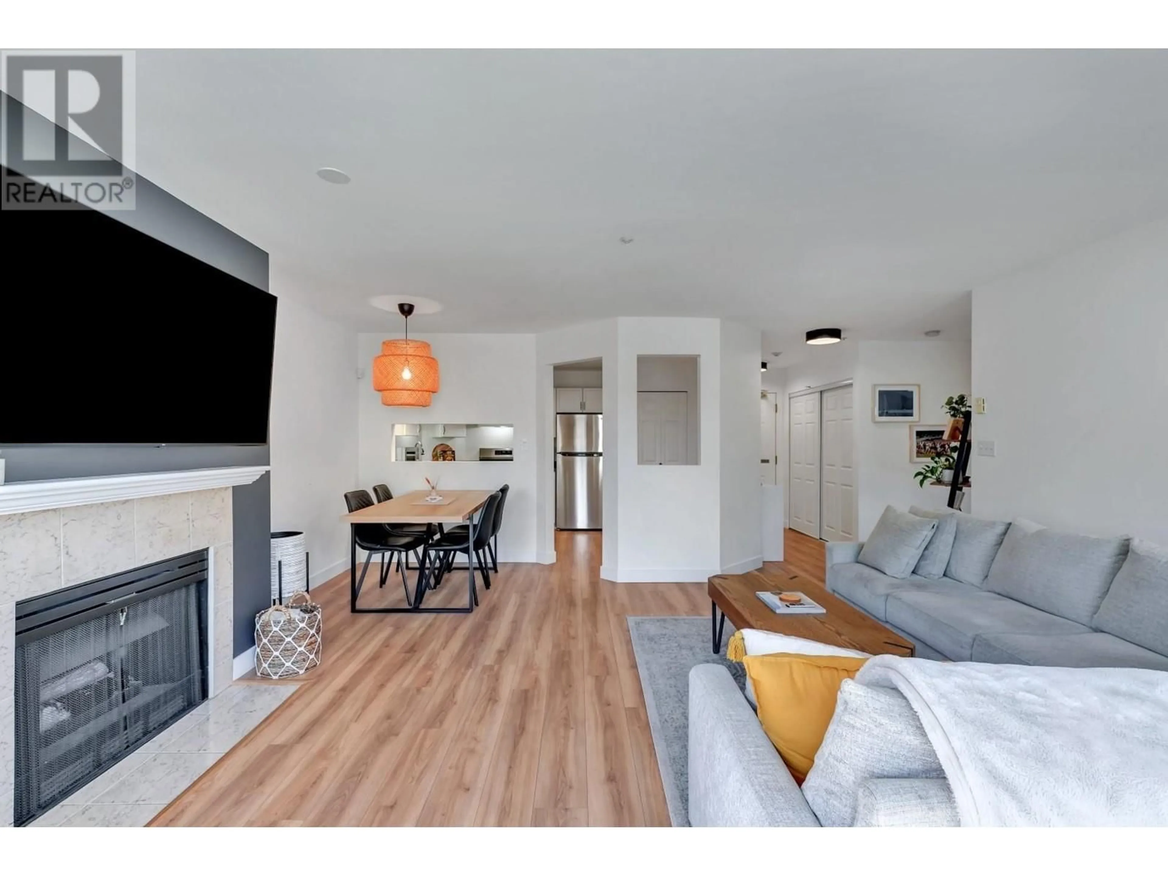 Living room with furniture, wood/laminate floor for 102 - 3400 MARINE DRIVE, Vancouver British Columbia V5S4P8