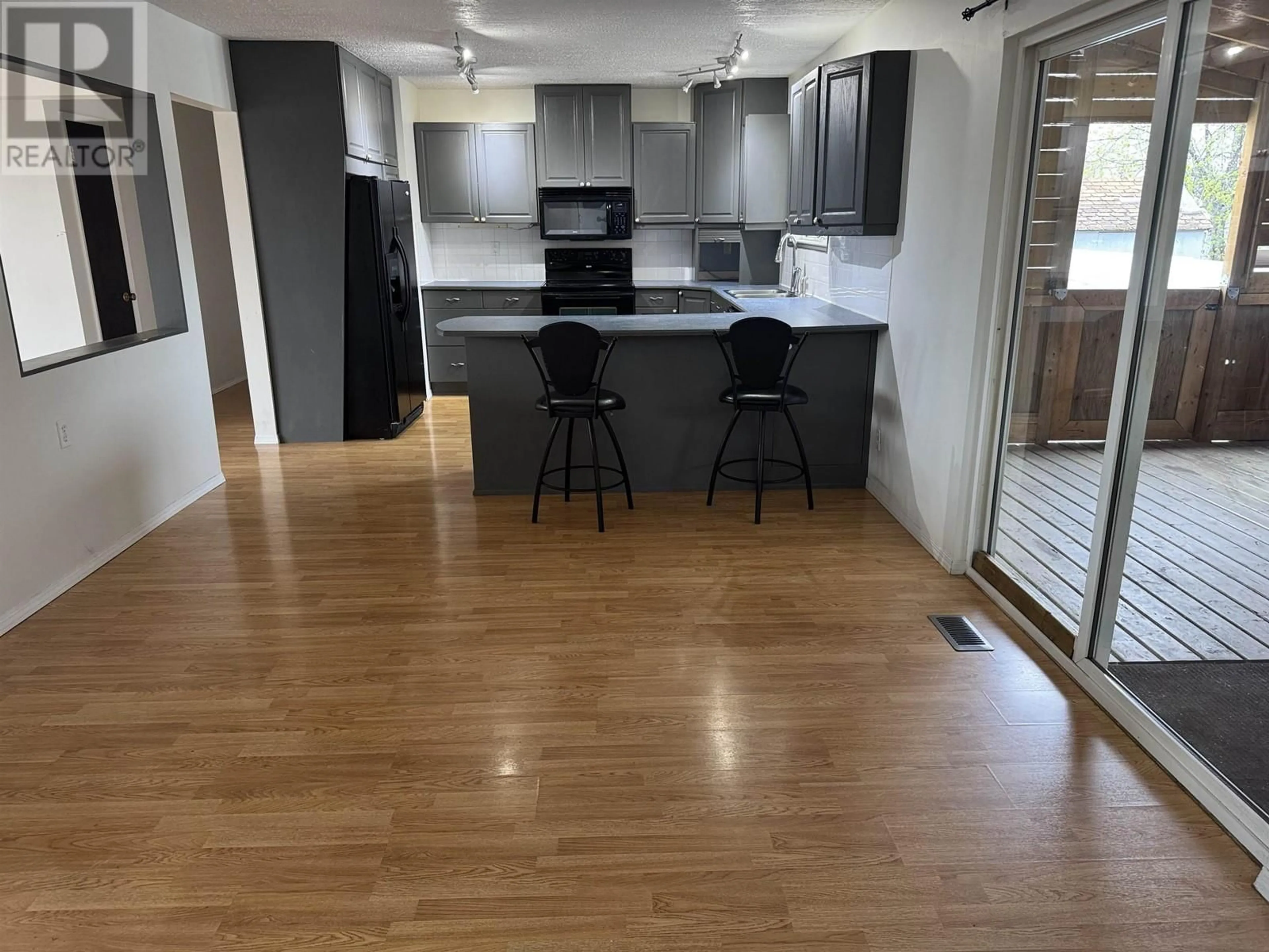 Open concept kitchen, wood/laminate floor for 18 TUTU AVENUE, Mackenzie British Columbia V0J2C0