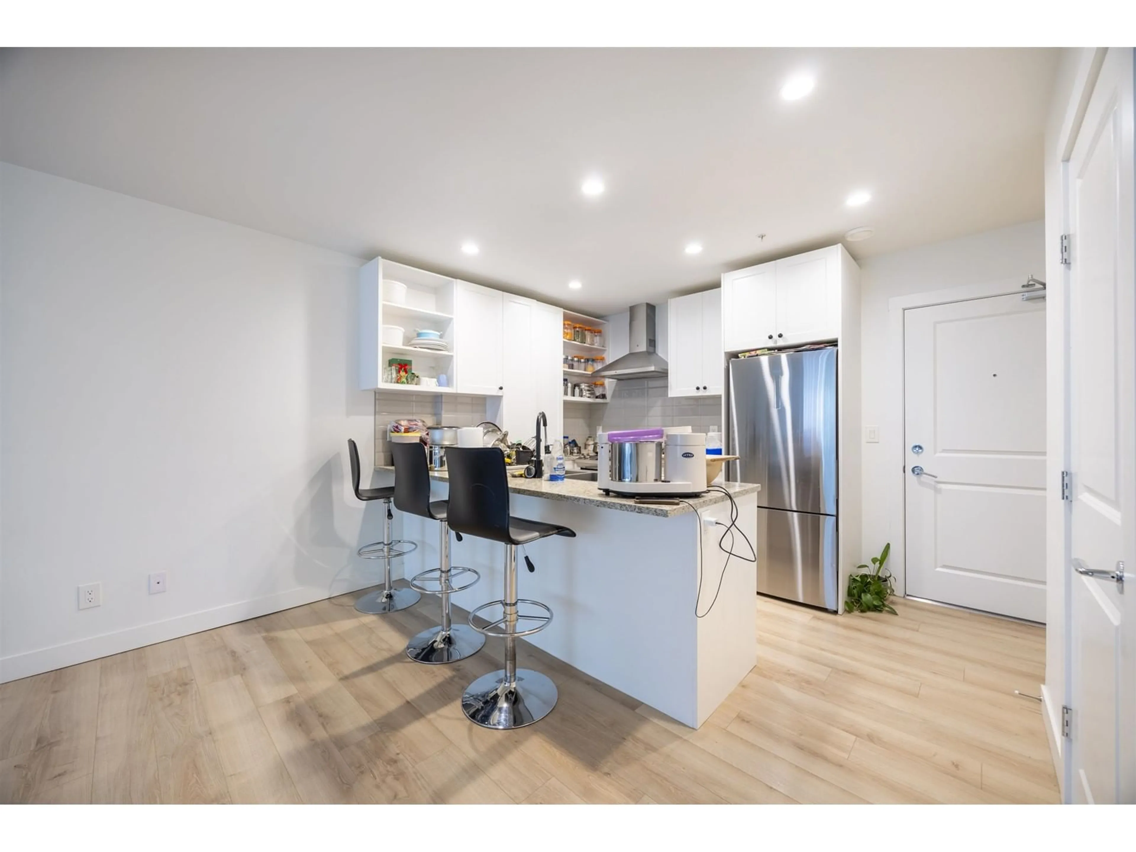 Open concept kitchen, wood/laminate floor for A104 - 20487 65, Langley British Columbia V2Y3K8