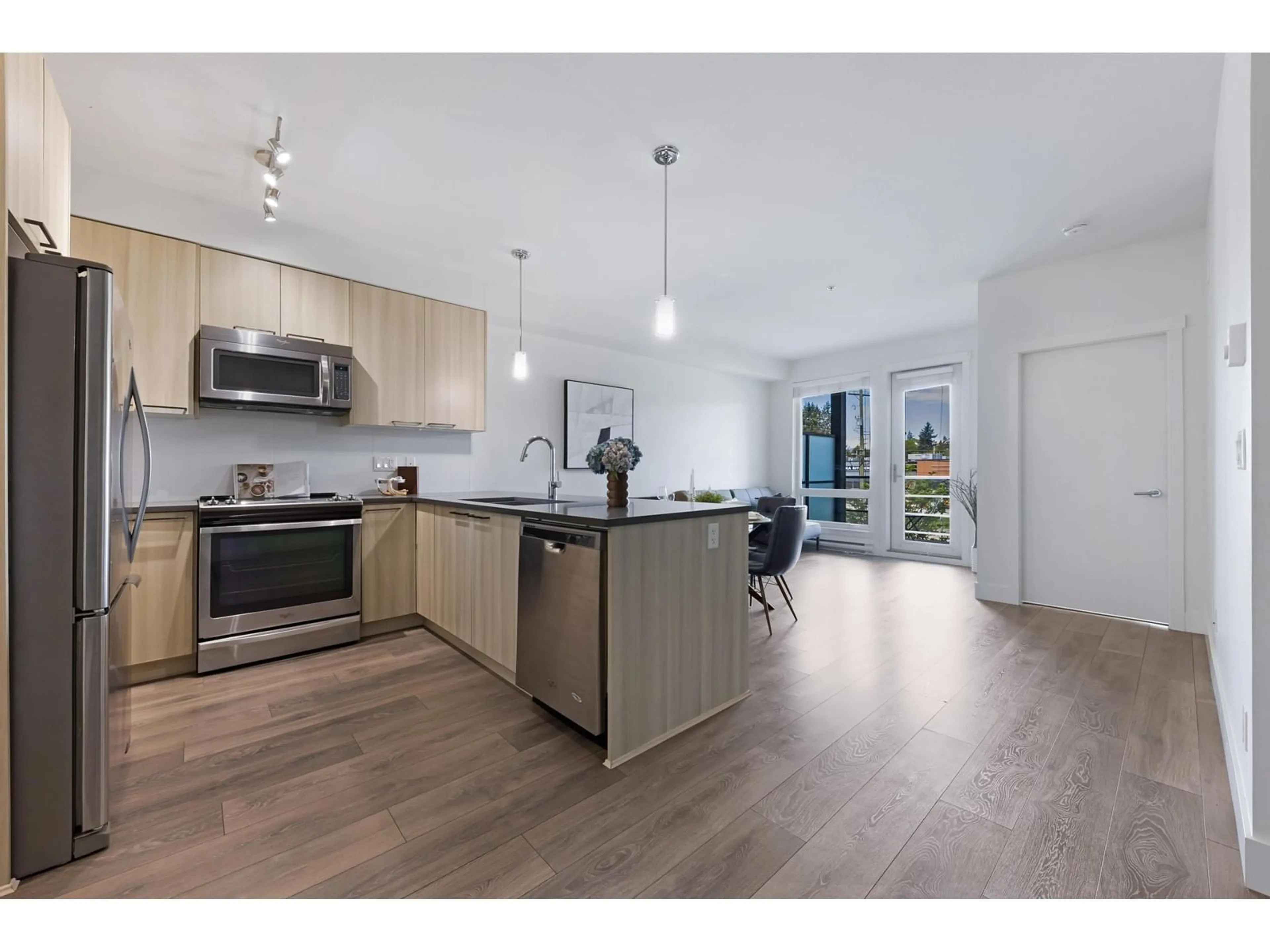 Open concept kitchen, wood/laminate floor for 204 - 15628 104, Surrey British Columbia V4N2J3