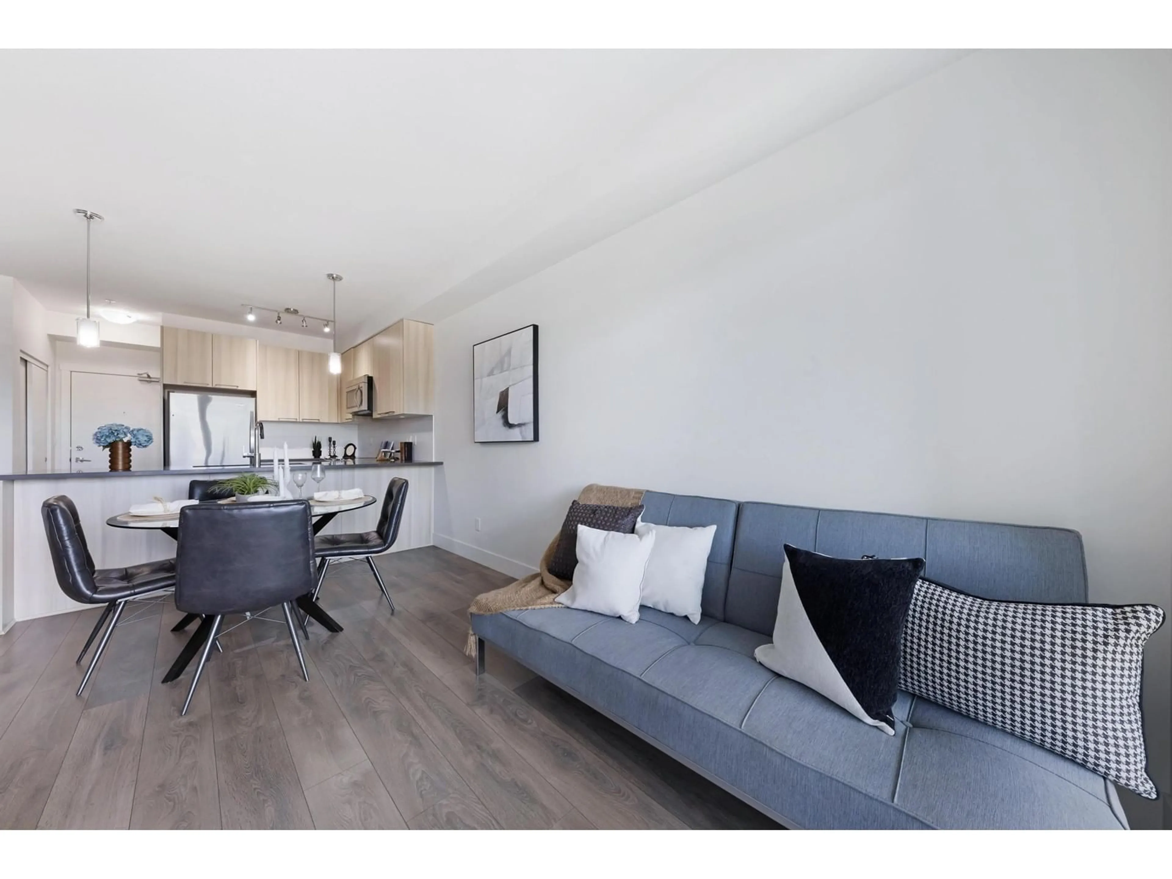 Living room with furniture, wood/laminate floor for 204 - 15628 104, Surrey British Columbia V4N2J3